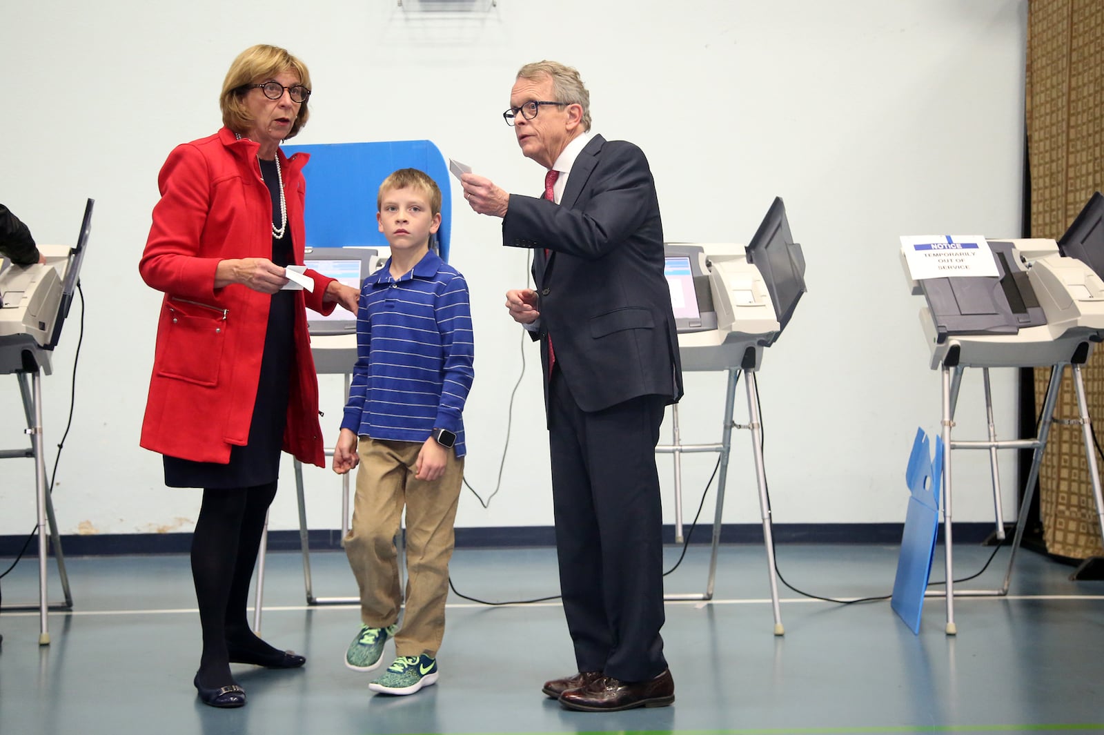 Attorney General Mike DeWine and his wife, Fran, accompanied by their 8-year-old grandson, Parker, voted Tuesday morning at Grace Baptist Church in Cedarville. DeWine and Rich Cordray are in the race for governor of Ohio. LISA POWELL / STAFF