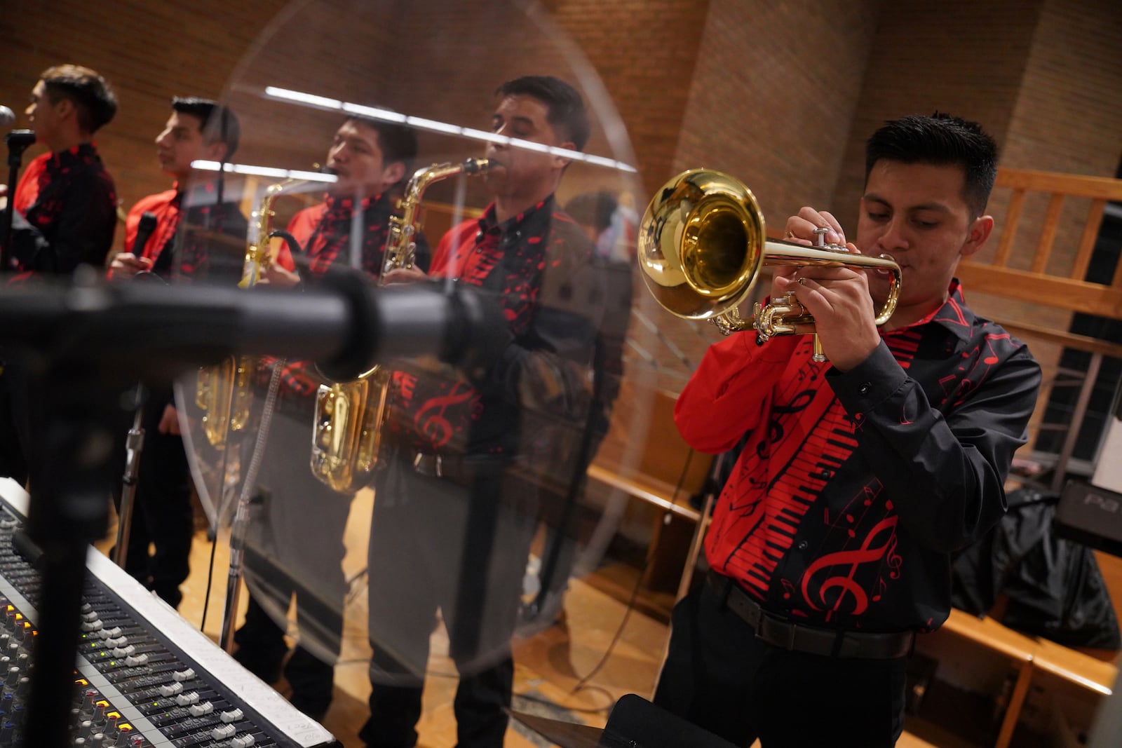 The choir “Nueva Inspiración” plays during the Spanish-language Mass at St. Mary’s Catholic Church on Saturday, Oct. 19, 2024, in Worthington, Minn. (AP Photo/Jessie Wardarski)