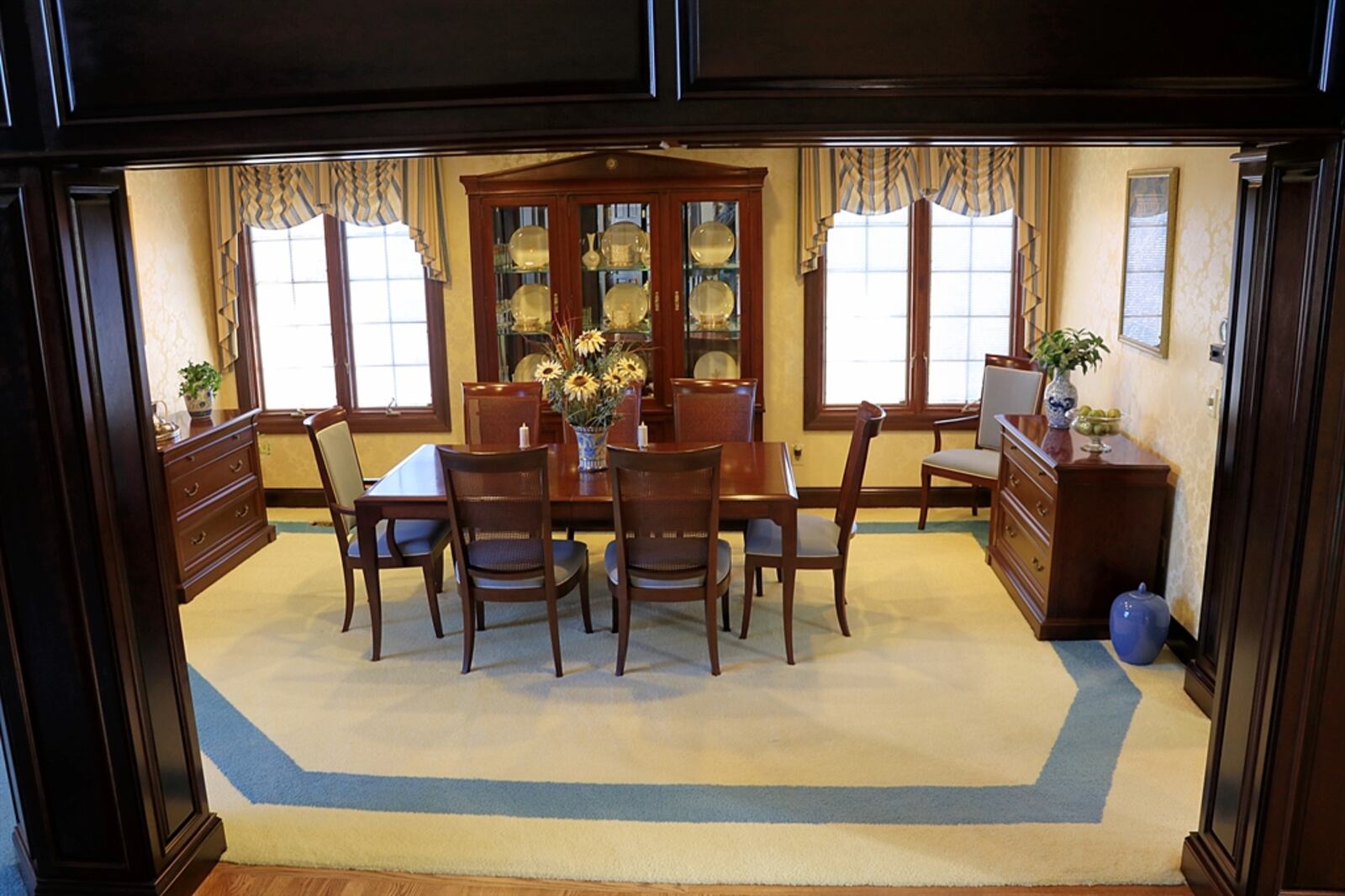 Dark wood paneling frames the formal dining room.