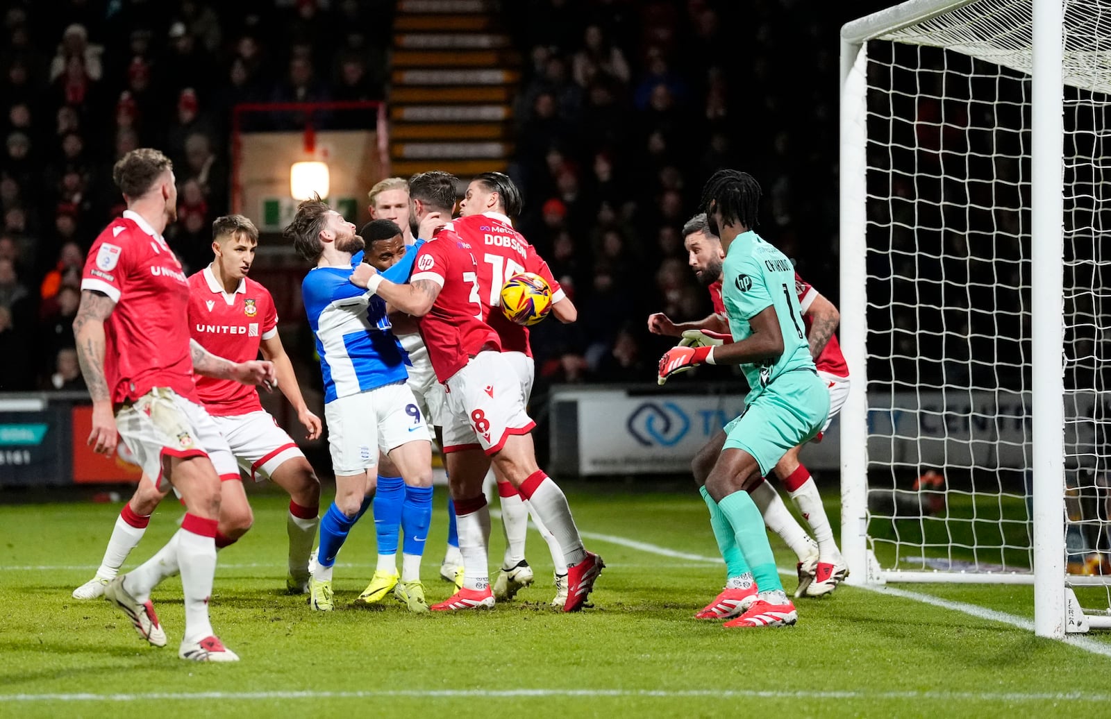 Birmingham City's Alfie May vies for the ball as Birmingham City's Lyndon Dykes scores his side's first goal during the English Football League One soccer match between Wrexham and Birmingham City at the SToK Racecourse, in Wrexham, Wales, Thursday, Jan. 23, 2025. (Nick Potts/PA via AP)