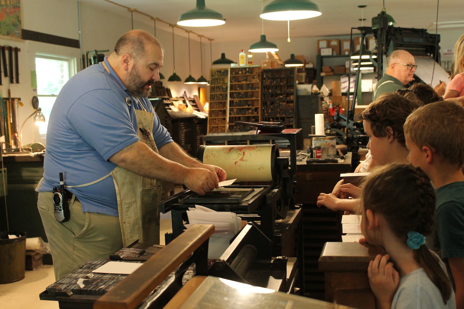 A volunteer demonstrates how to print a postcard for visitors. CONTRIBUTED