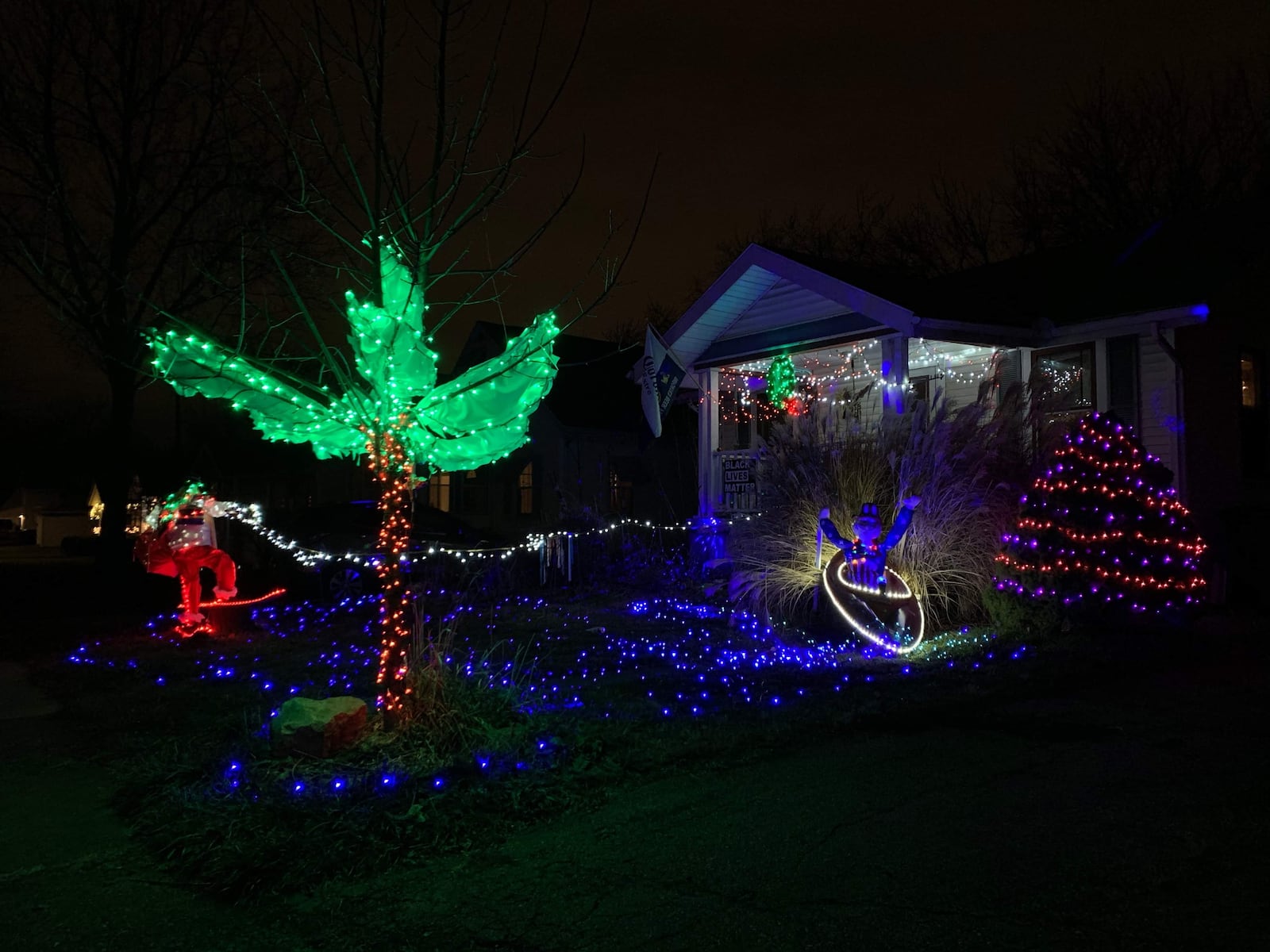 A hilarious skiing Santa is accompanied by Uncle Sam in a canoe at one Belmont home. CONTRIBUTED