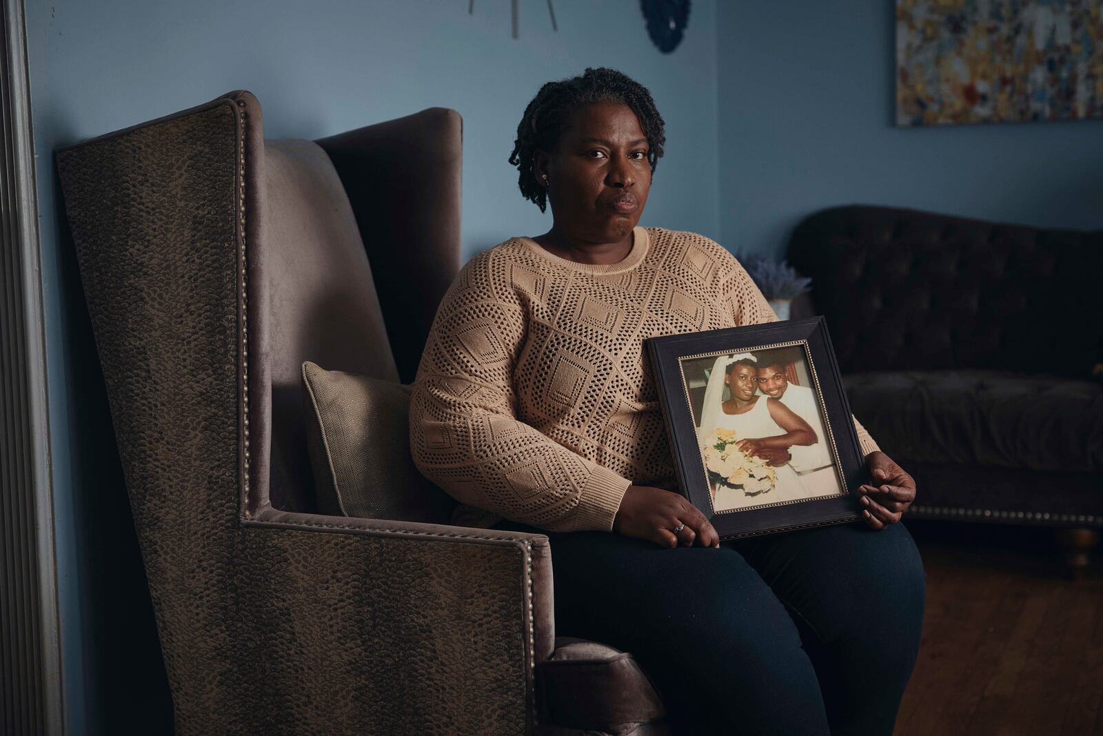 Sharline Volcy holds a wedding picture of her and her deceased husband, Roland Donat's, on Monday, Feb. 3, 2025, in Orange, N.J. (AP Photo/Andres Kudacki)