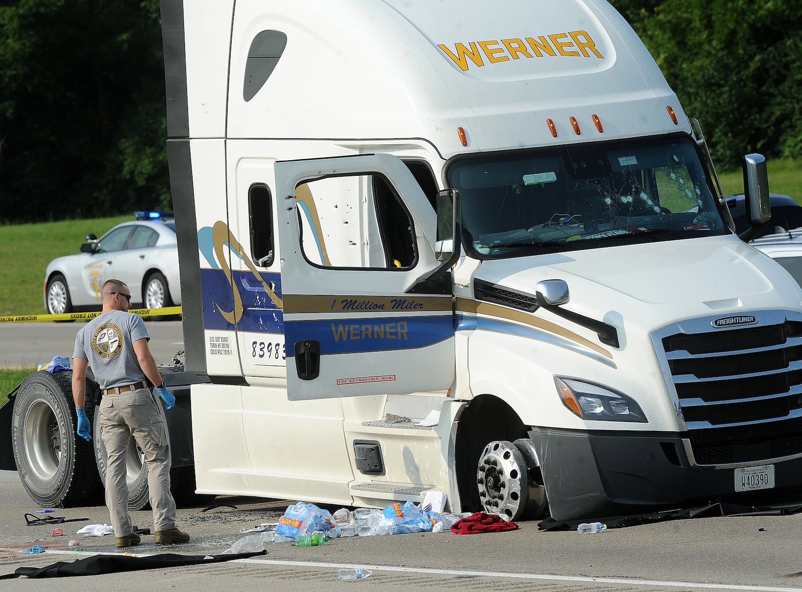 A member of BCI looks over a semi that was highjacked from London and stopped near the Dayton Airport early Wednesday morning Aug. 2, 2023. One of two suspects involved in the multi-county chase and hours-long hostage situation has died after being shot by troopers. MARSHALL GORBY\STAFF