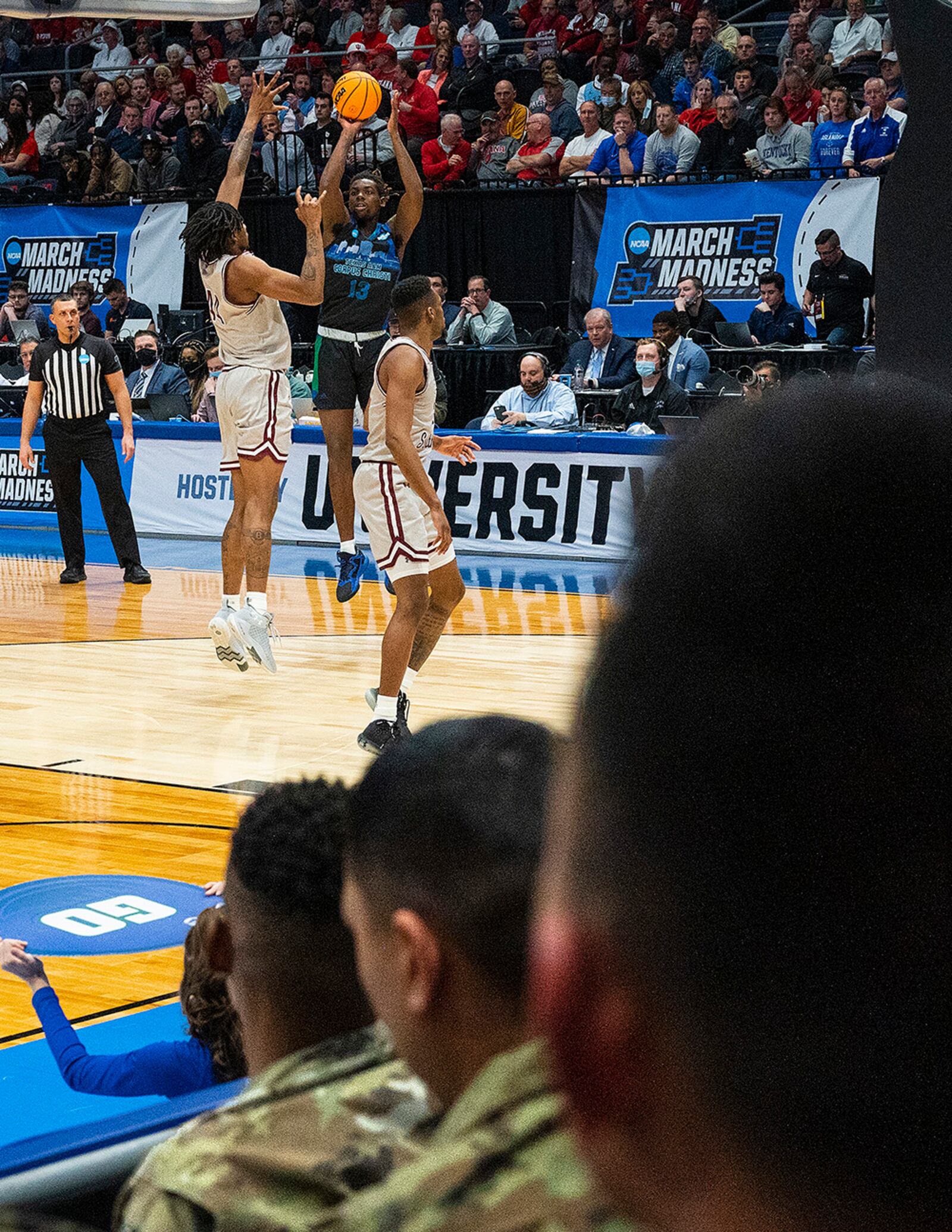 Airmen watch as Texas A&M-Corpus Christi’s De’Lazarus Keys shoots over Texas Southern’s Brison Gresham in the first game of the NCAA men’s basketball tournament March 15 at University of Dayton Arena. Airmen from Wright-Patterson Air Force Base took part in the opening ceremony and received free tickets. U.S. AIR FORCE PHOTO/R.J. ORIEZ