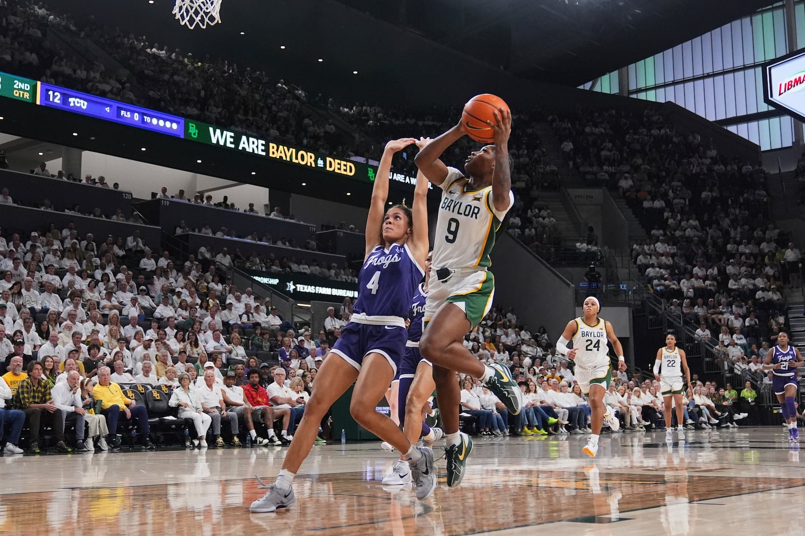 Baylor guard Aliyah Matharu (9) takes a shot as TCU's Donovyn Hunter (4) defends in the first half of an NCAA college basketball game in Waco, Texas, Sunday, March 2, 2025. (AP Photo/Tony Gutierrez)