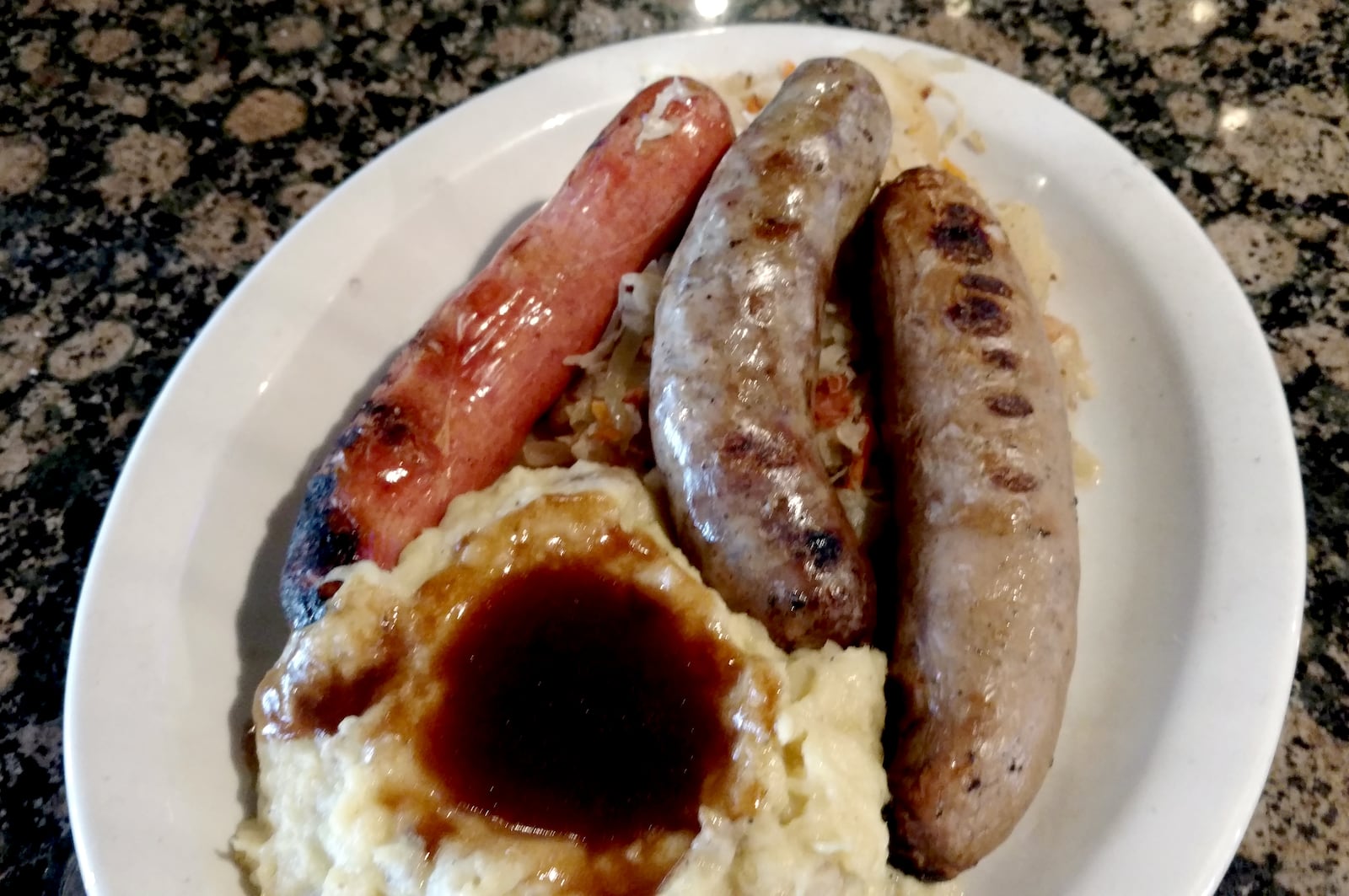 Amber Rose's Three Sausage Sampler includes beer braised knockwurst, bratwurst and Polish sausage. It is served with house made sauerkraut and smashed Yukon gold Potatoes for $16.