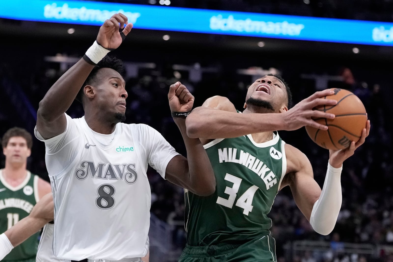 Milwaukee Bucks' Giannis Antetokounmpo tries to get past Dallas Mavericks' Olivier-Maxence Prosper during the second half of an NBA basketball game Wednesday, March 5, 2025, in Milwaukee. (AP Photo/Morry Gash)