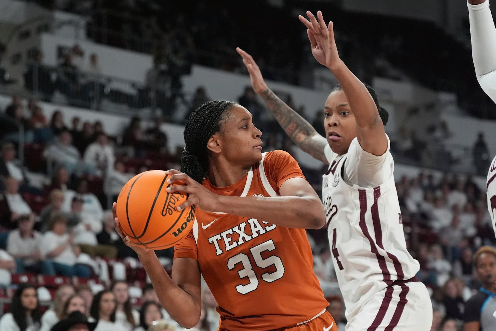 Texas forward Madison Booker (35) is pressured by Mississippi State guard Eniya Russell (4) during the second half of an NCAA college basketball game, Thursday, Feb. 27, 2025, in Starkville, Miss. (AP Photo/Rogelio V. Solis)