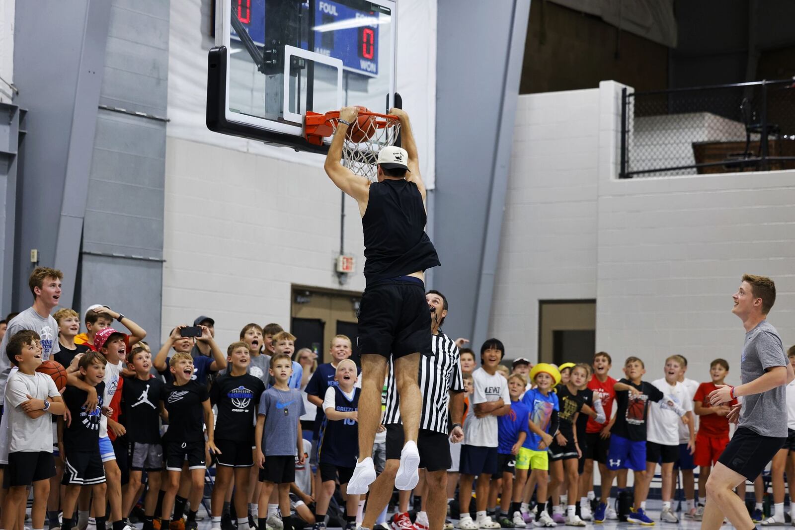 Luke Kennard dunks the ball during "One Special Game" basketball game held for those with special needs during the Luke Kennard basketball camp at Camp Chautauqua Saturday, July 20, 2024. Camp attendees cheered on the players during the event. NICK GRAHAM/STAFF