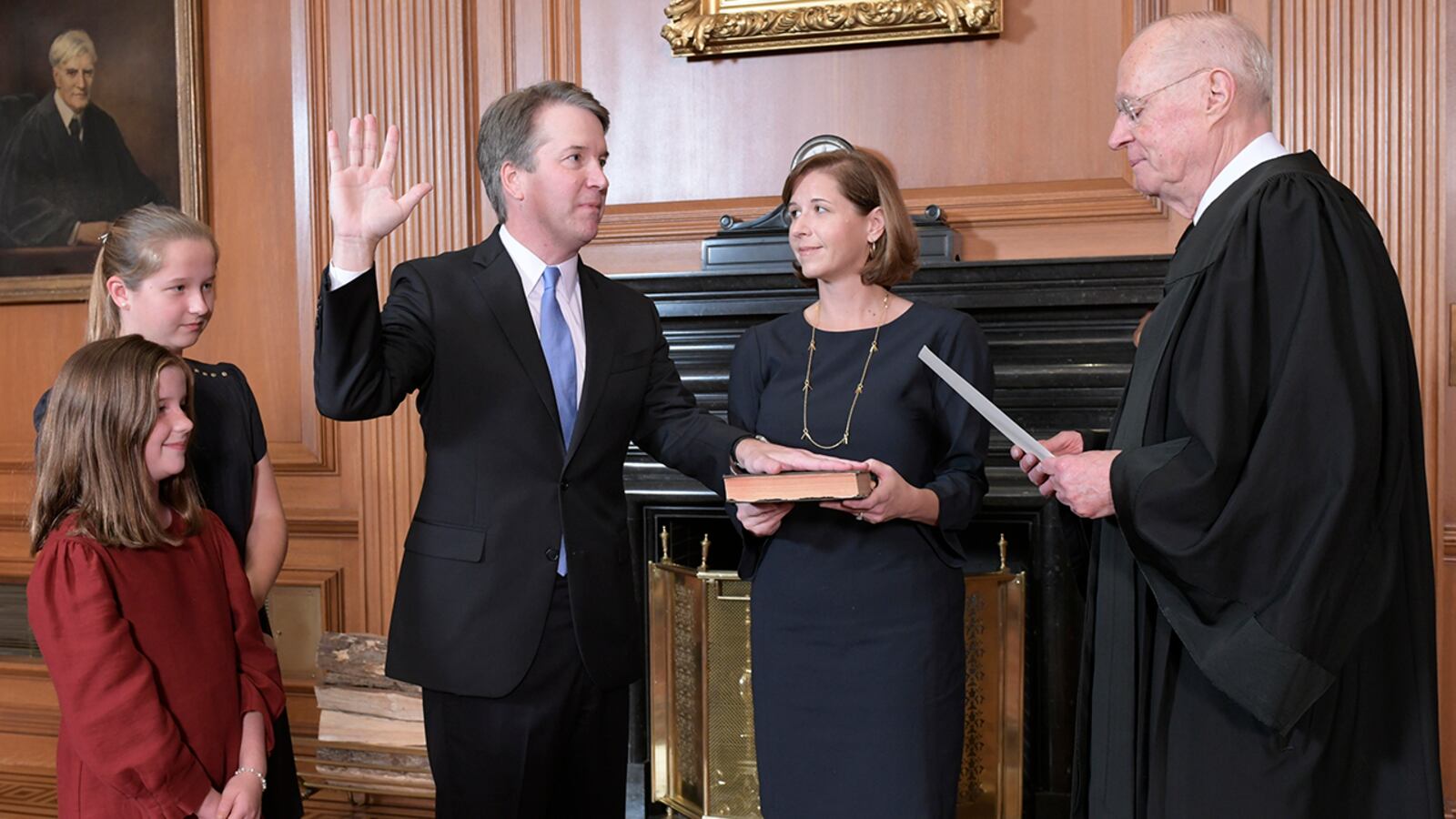 Retired Justice Anthony M. Kennedy, right, administers the Judicial Oath to Judge Brett Kavanaugh in the Justices' Conference Room of the Supreme Court Building. Ashley Kavanaugh holds the Bible. At left are their daughters, Margaret, background, and Liza. (Fred Schilling/Collection of the Supreme Court of the United States via AP)