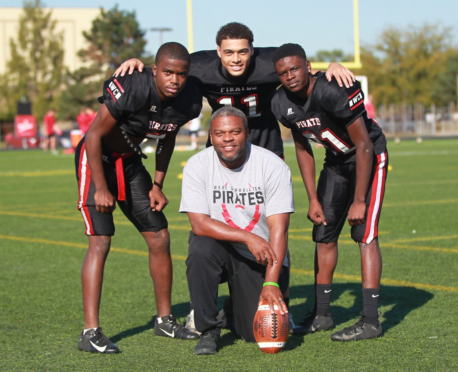 West Carrollton High School football standouts Kamaury Cleveland (left), Austin Jones (middle back) and Cedric Anthony and head coach Dion Black during practice on Wednesday, Oct. 9, 2019. MARC PENDLETON / STAFF