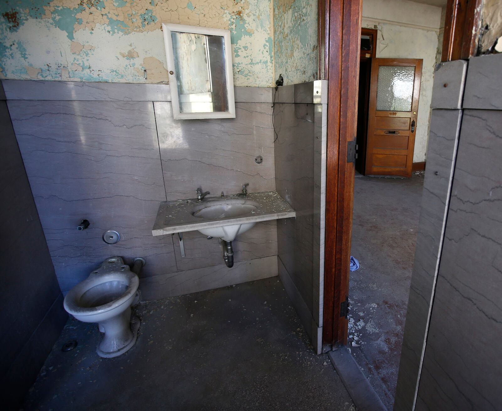 Shared bathroom in a Third Street Arcade apartment features original marble fixtures and walls contrasting with the oak woodwork of the living space.  Apartments like these are on track to be renovated along with the Dayton Arcade.    TY GREENLEES / STAFF