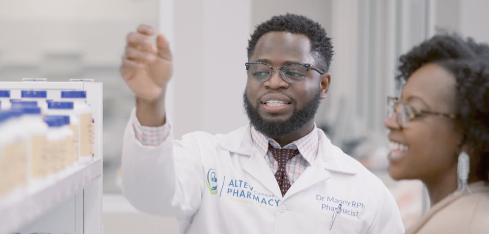 Dr. Emmanuel Ayanjoke discusses various prescription drug options with a patient at Altev Pharmacy in Cincinnati. COURTESY PHOTO