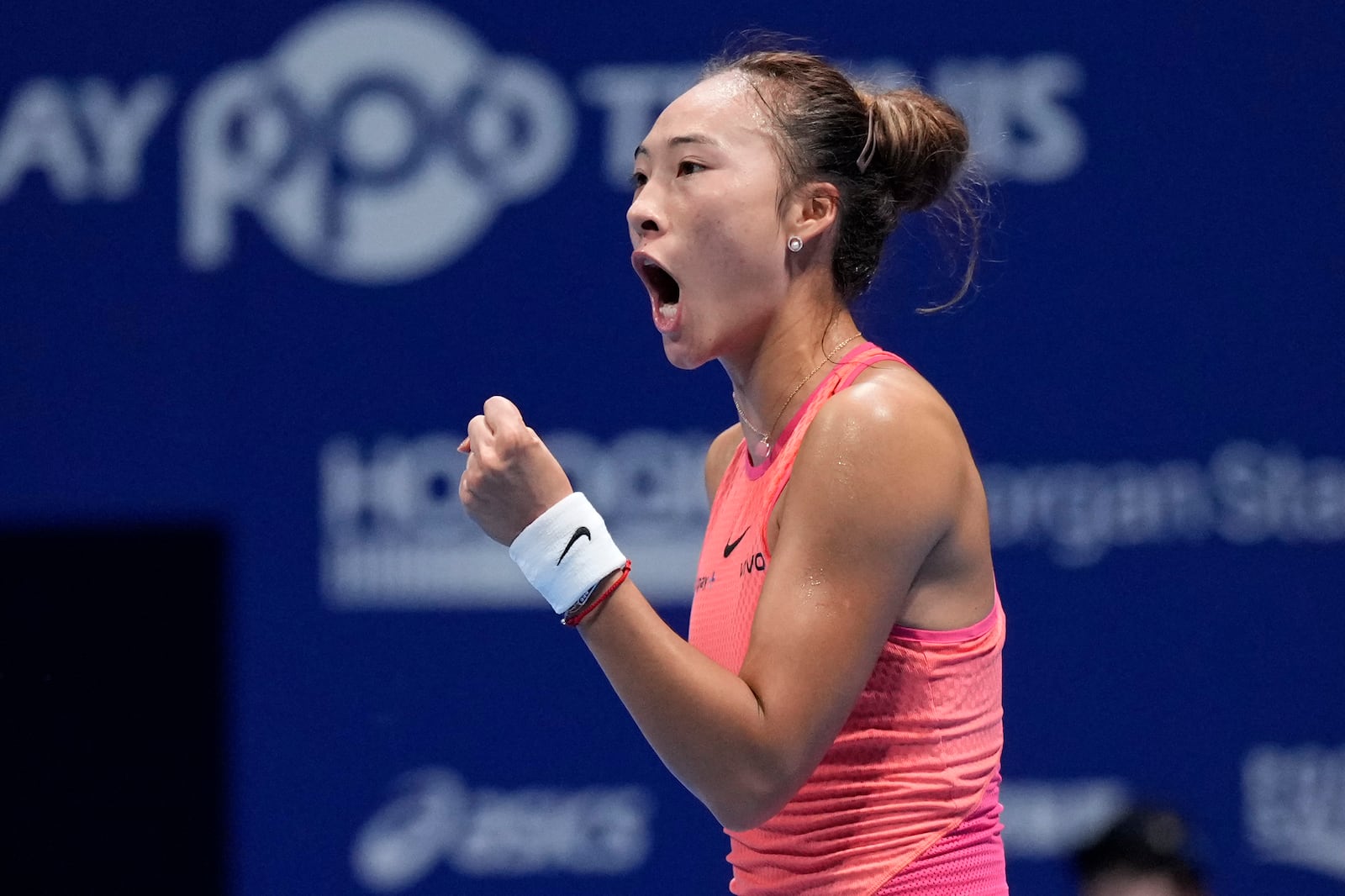 China's Zheng Qinwen reacts after winning a point against Sofia Kenin of the United States during the final match of the Pan Pacific Open women's tennis tournament at Ariake Coliseum, in Tokyo, Sunday, Oct. 27, 2024. (AP Photo/Eugene Hoshiko)