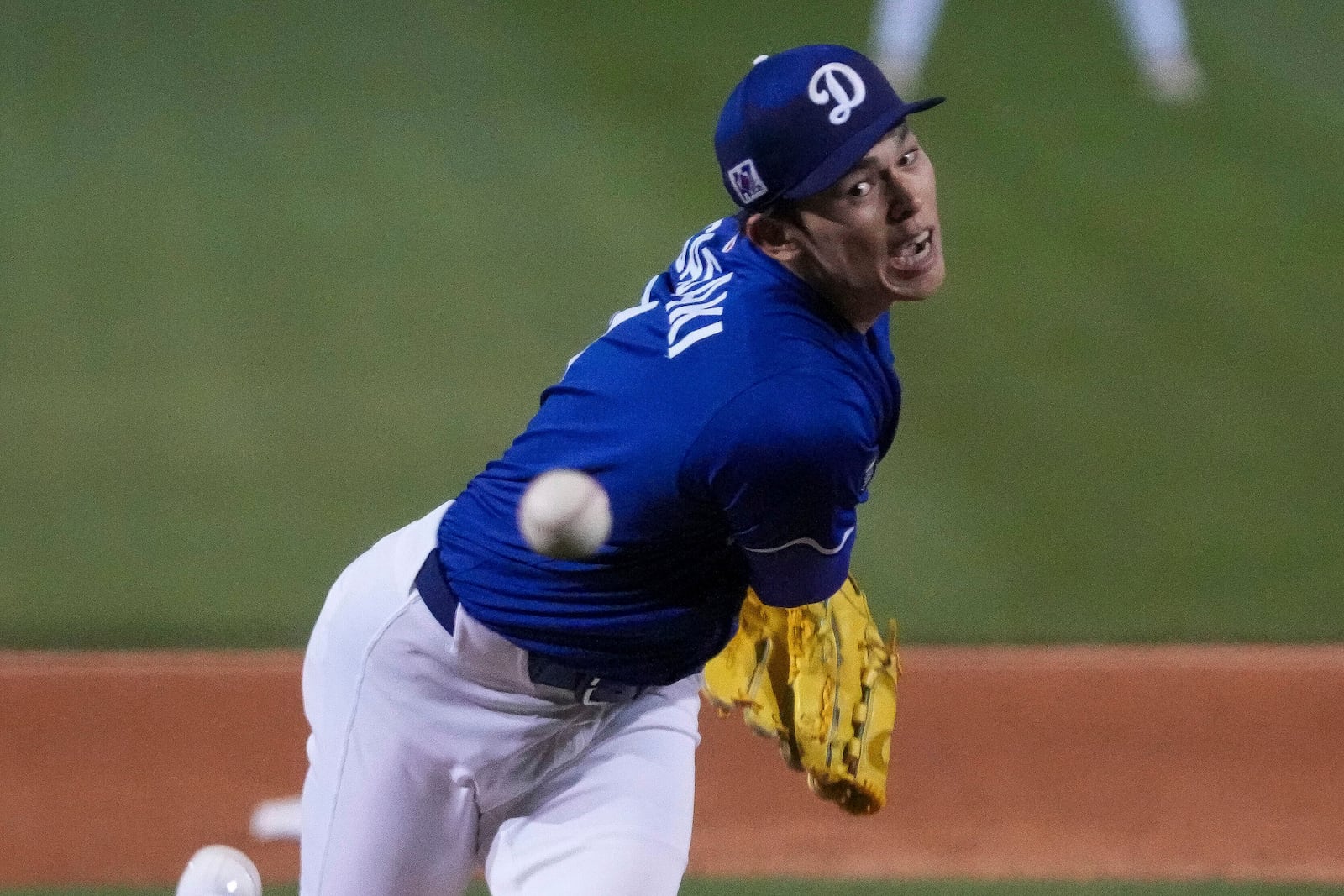 Los Angeles Dodgers pitcher Roki Sasaki (11) throws during the sixth inning of a spring training baseball game against the Cincinnati Reds, Tuesday, March. 4, 2025, in Phoenix. (AP Photo/Darryl Webb)