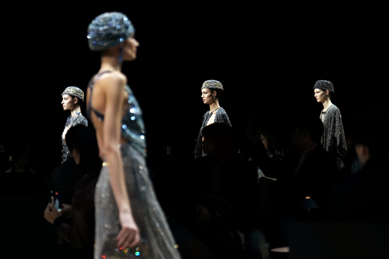 Models wear creations as part of the Giorgio Armani Fall/Winter 2025-2026 Women's collection presented in Milan, Italy, Sunday, March 2, 2025. (AP Photo/Luca Bruno)