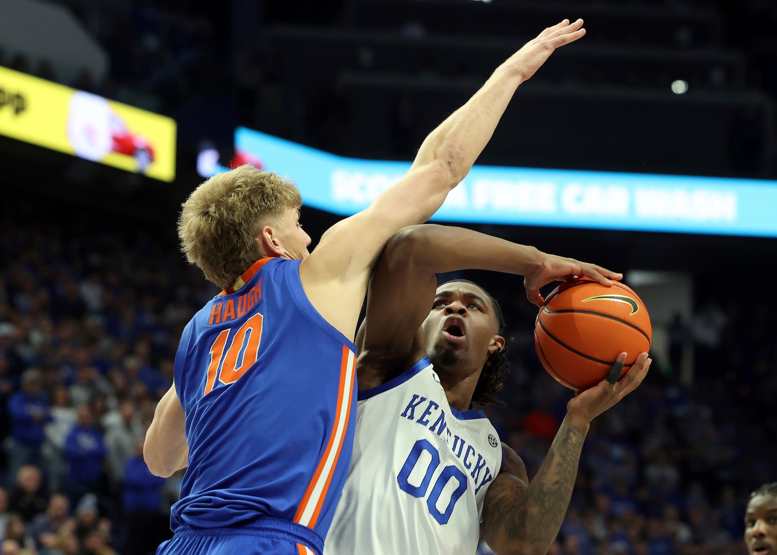 Kentucky's Otega Oweh (00) shoots while pressured by Florida's Thomas Haugh (10) during the first half of an NCAA college basketball game in Lexington, Ky., Saturday, Jan. 4, 2025. (AP Photo/James Crisp)