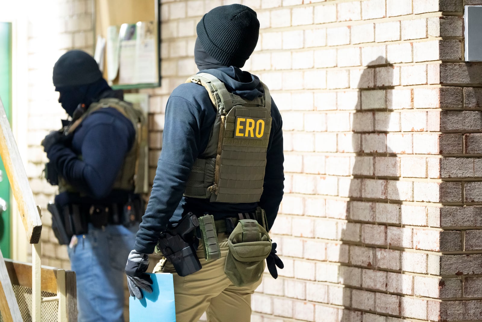 U.S. Immigration and Customs Enforcement officers wait to detain a person, Monday, Jan. 27, 2025, in Silver Spring, Md. (AP Photo/Alex Brandon)