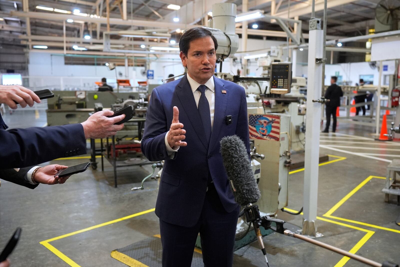 U.S. Secretary of State Marco Rubio speaks to the media during a visit to workshops of aircraft maintenance firm Aeroman in San Luis Talpa, El Salvador, Monday, Feb. 3, 2025. (AP Photo/Mark Schiefelbein, Pool)