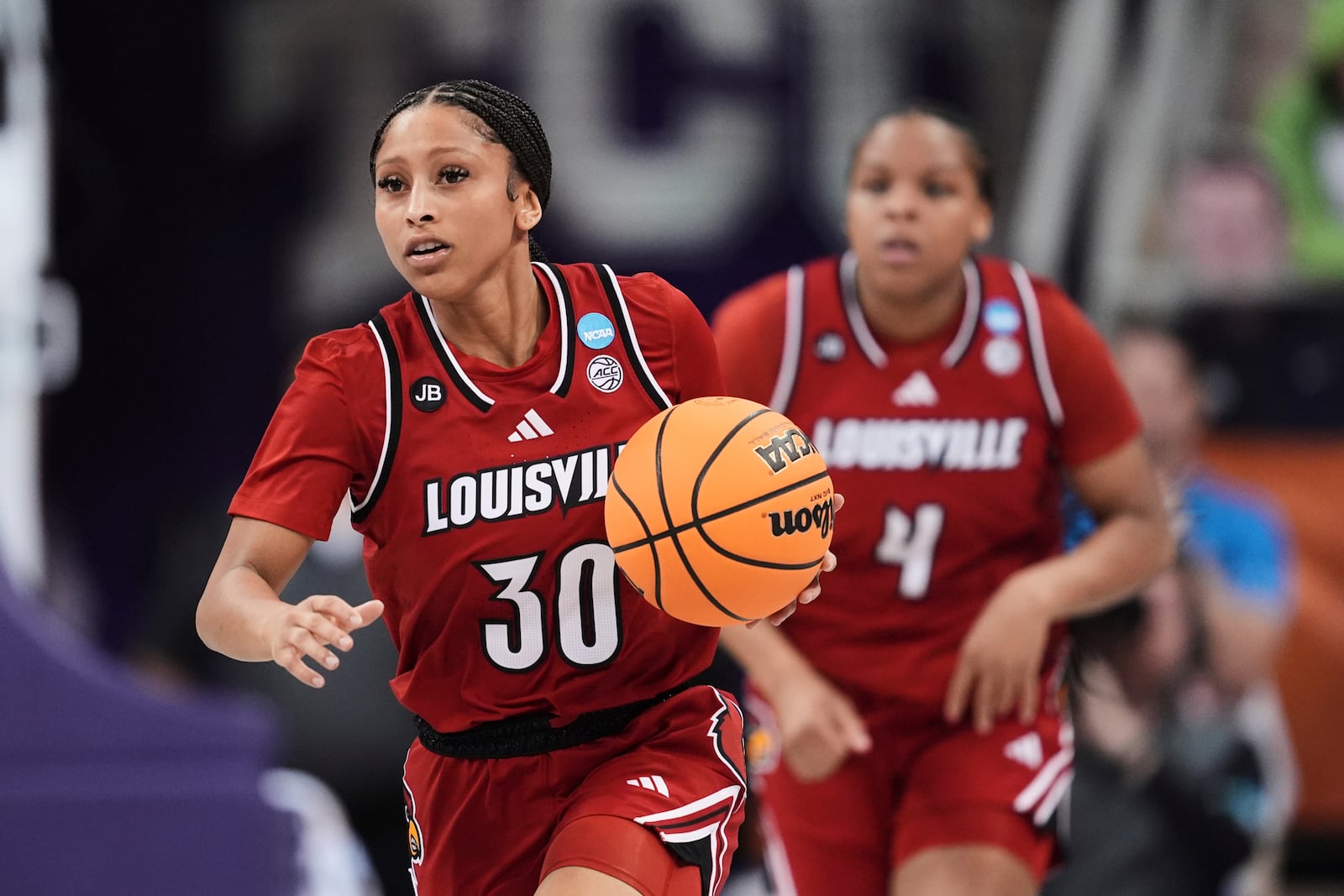 Louisville's Jayda Curry (30) advances the ball upcourt against TCU in the first half in the second round of the NCAA college basketball tournament in Fort Worth, Texas, Sunday, March 23, 2025. (AP Photo/Tony Gutierrez)