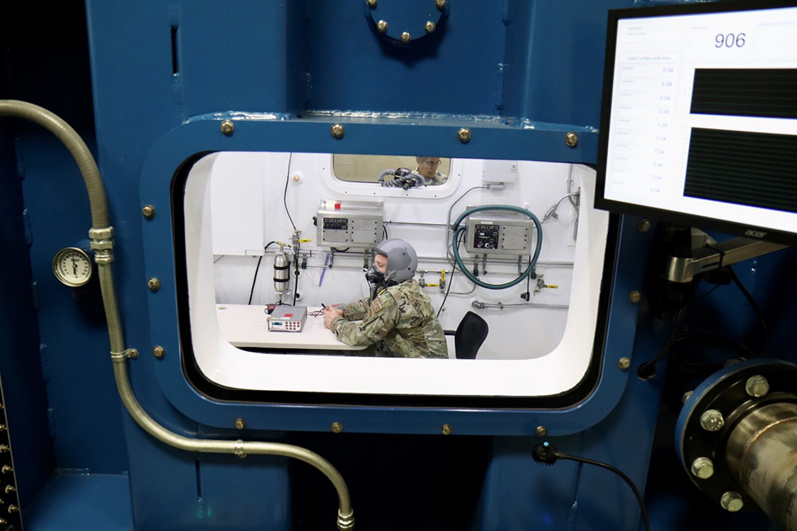 Tech. Sgt. Tyler Wineman sits inside a Research Altitude Chamber during an oxygen system test at Wright Patterson Air Force Base April 15. U.S. AIR FORCE PHOTO/JASON SCHAAP