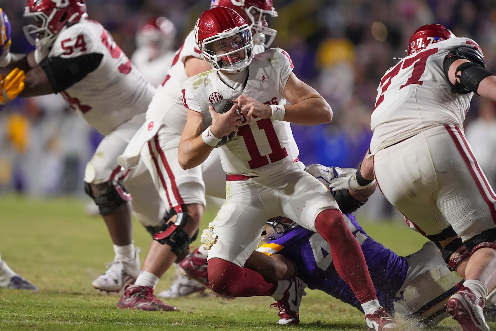 Oklahoma quarterback Jackson Arnold (11) is sacked by LSU linebacker Davhon Keys (42) in the second half an NCAA college football game in Baton Rouge, La., Saturday, Nov. 30, 2024. LSU won 37-17. (AP Photo/Gerald Herbert)