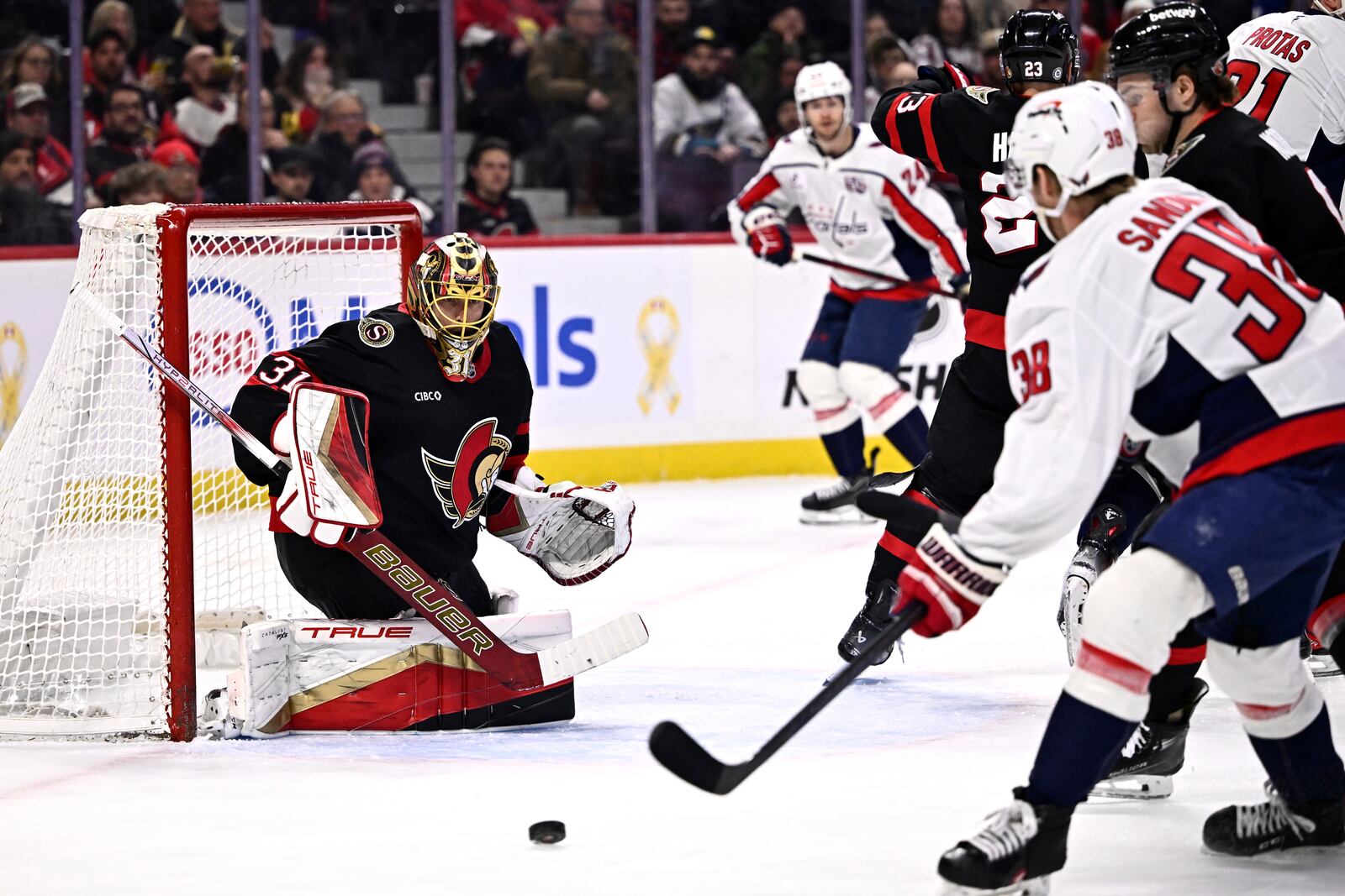 Ottawa Senators goaltender Anton Forsberg (31) watches the puck as Washington Capitals' Rasmus Sandin (38) looks for a shot during first-period NHL hockey game action in Ottawa, Ontario, Thursday, Jan. 30, 2025. (Justin Tang/The Canadian Press via AP)