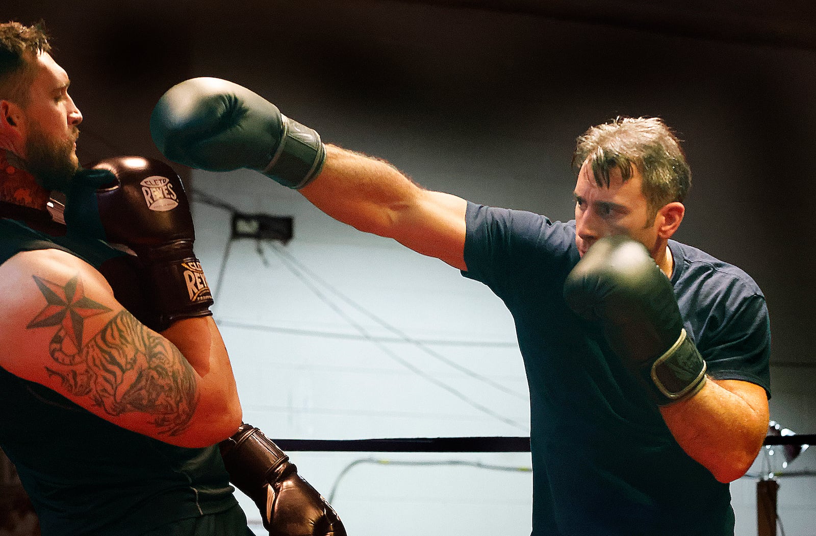 Xenia firefighter Warren Roberds, right, trains at Drake's Downtown Gym in Dayton ahead of the Dawg Fight charity exhibition tournament next Thursday. MARSHALL GORBY\STAFF