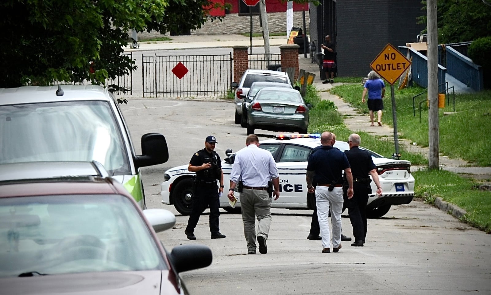 Dayton police search for shell casings Wednesday, June 8, 2022, in the 100 block of Marathon Avenue after a man was firing shots into the air. MARSHALL GORBY/STAFF