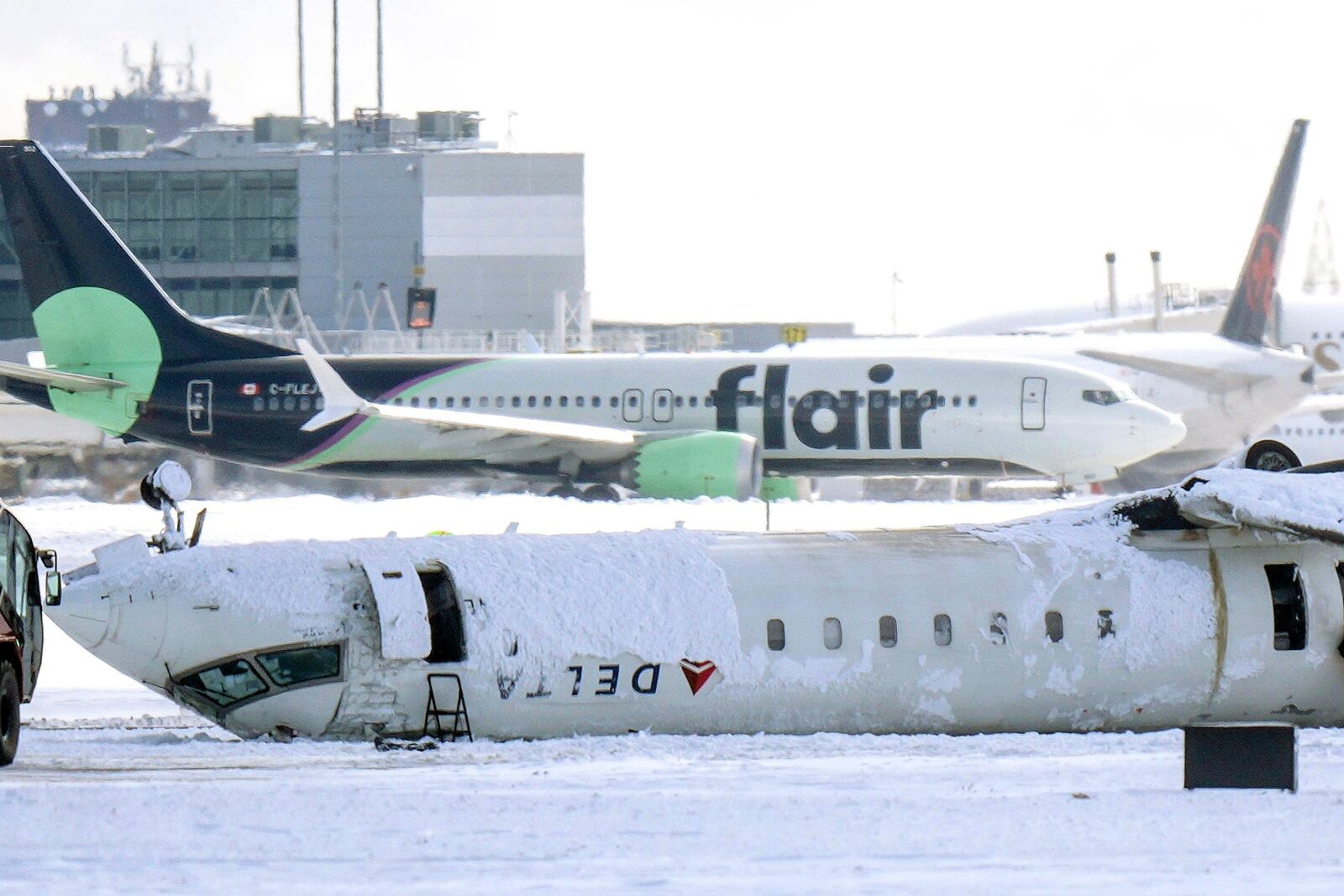 A Delta Air Lines plane lies upside down at Toronto Pearson Airport on Tuesday, Feb. 18, 2025. (Chris Young/The Canadian Press via AP)