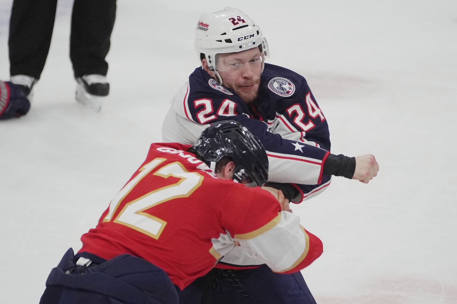 Columbus Blue Jackets right wing Mathieu Olivier (24) throws a punch at Florida Panthers left wing Jonah Gadjovich (12) during the first period of an NHL hockey game, Thursday, March 6, 2025, in Sunrise, Fla. (AP Photo/Marta Lavandier)