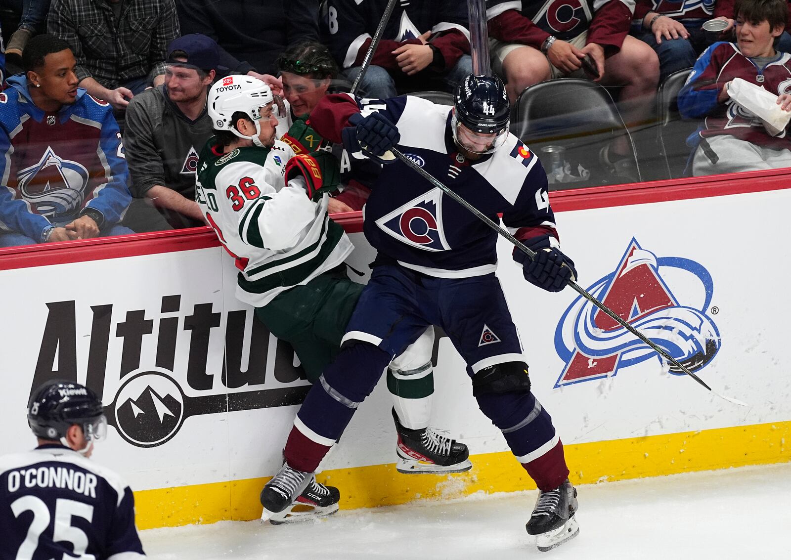 Colorado Avalanche defenseman Calvin de Haan, right, checks Minnesota Wild right wing Mats Zuccarello in the third period of an NHL hockey game Friday, Feb. 28, 2025, in Denver. (AP Photo/David Zalubowski)