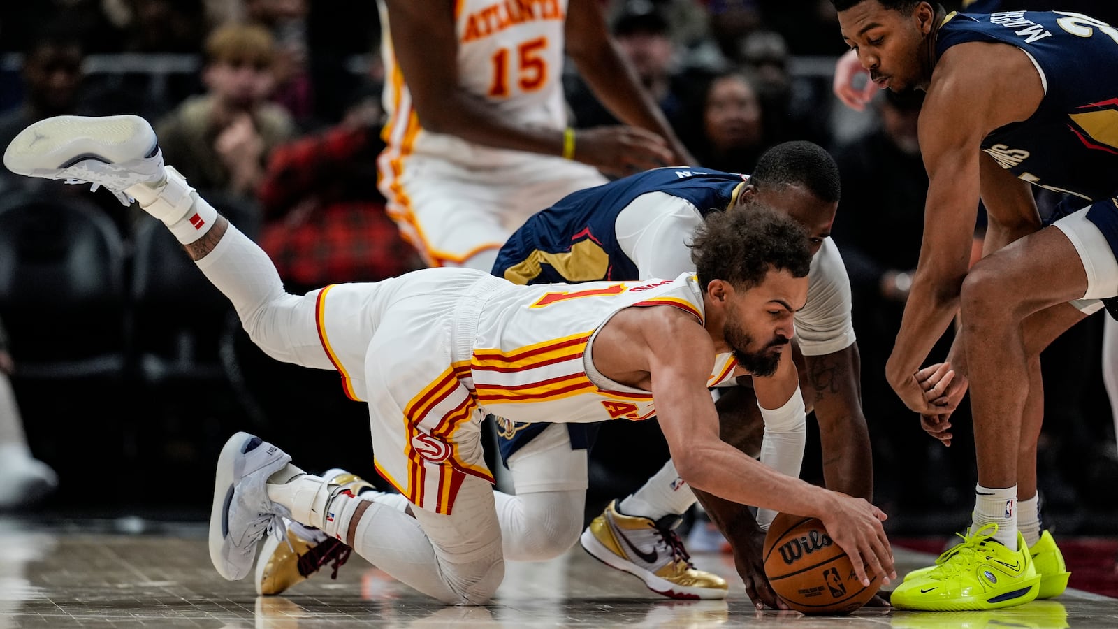 Atlanta Hawks guard Trae Young (11) vies for a loose ball with New Orleans Pelicans guard Javonte Green (4) during the first half of an NBA basketball game, Monday, Dec. 2, 2024, in Atlanta. (AP Photo/Mike Stewart)