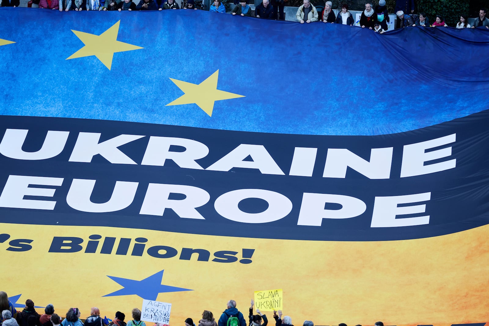 Activists unfurl a large banner in support of Ukraine outside the European Council building ahead of an EU summit in Brussels, Belgium, Wednesday, March 5, 2025. (AP Photo/Omar Havana)