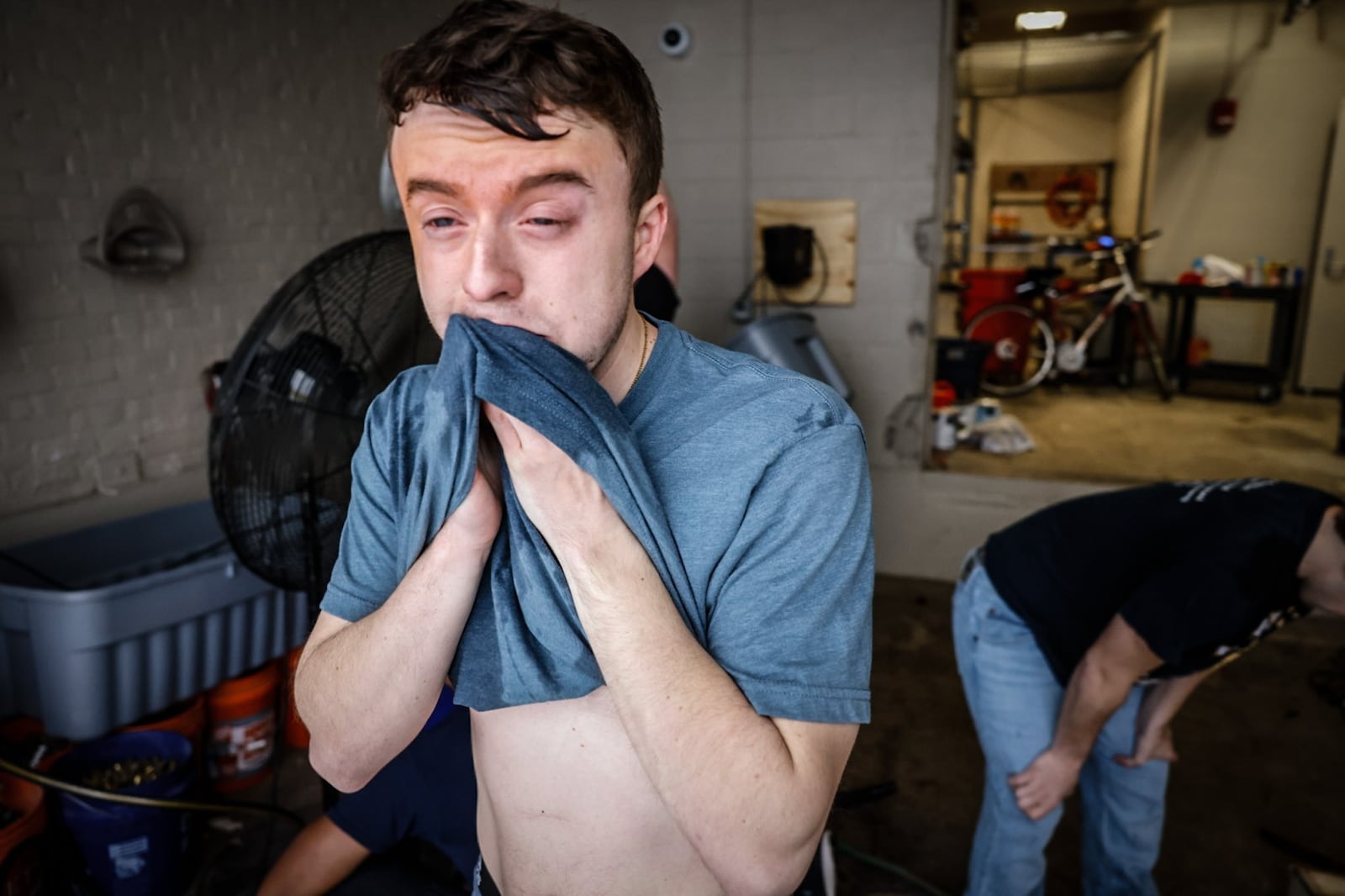 A Sinclair Collage police academy cadet wipes pepper spay off his face. About two dozen cadets were exposed to pepper spray to get an idea what is like to be sprayed by the chemical. JIM NOELKER/STAFF