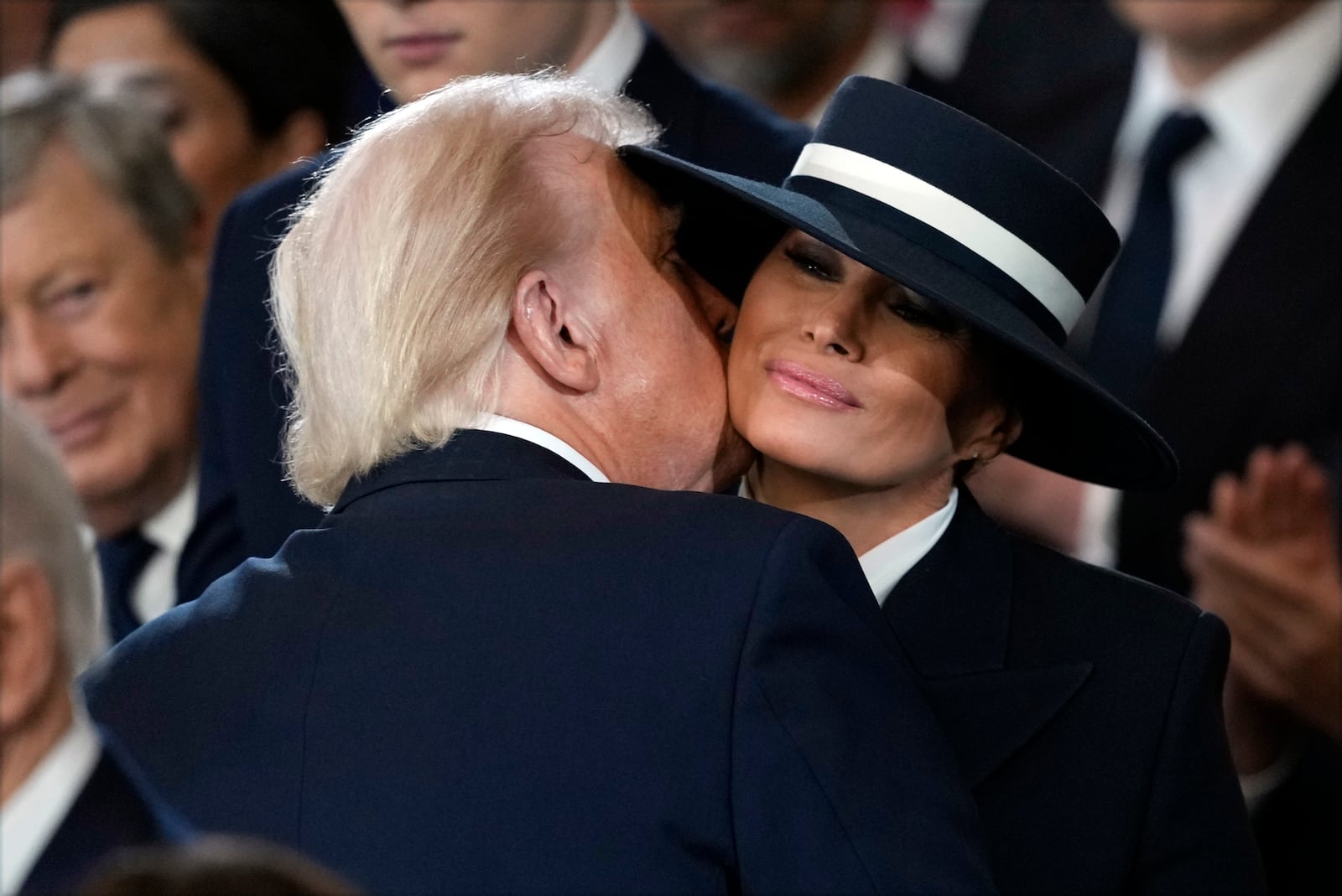 President Donald Trump kisses first lady Melania Trump during the 60th Presidential Inauguration in the Rotunda of the U.S. Capitol in Washington, Monday, Jan. 20, 2025. (AP Photo/Julia Demaree Nikhinson, Pool)