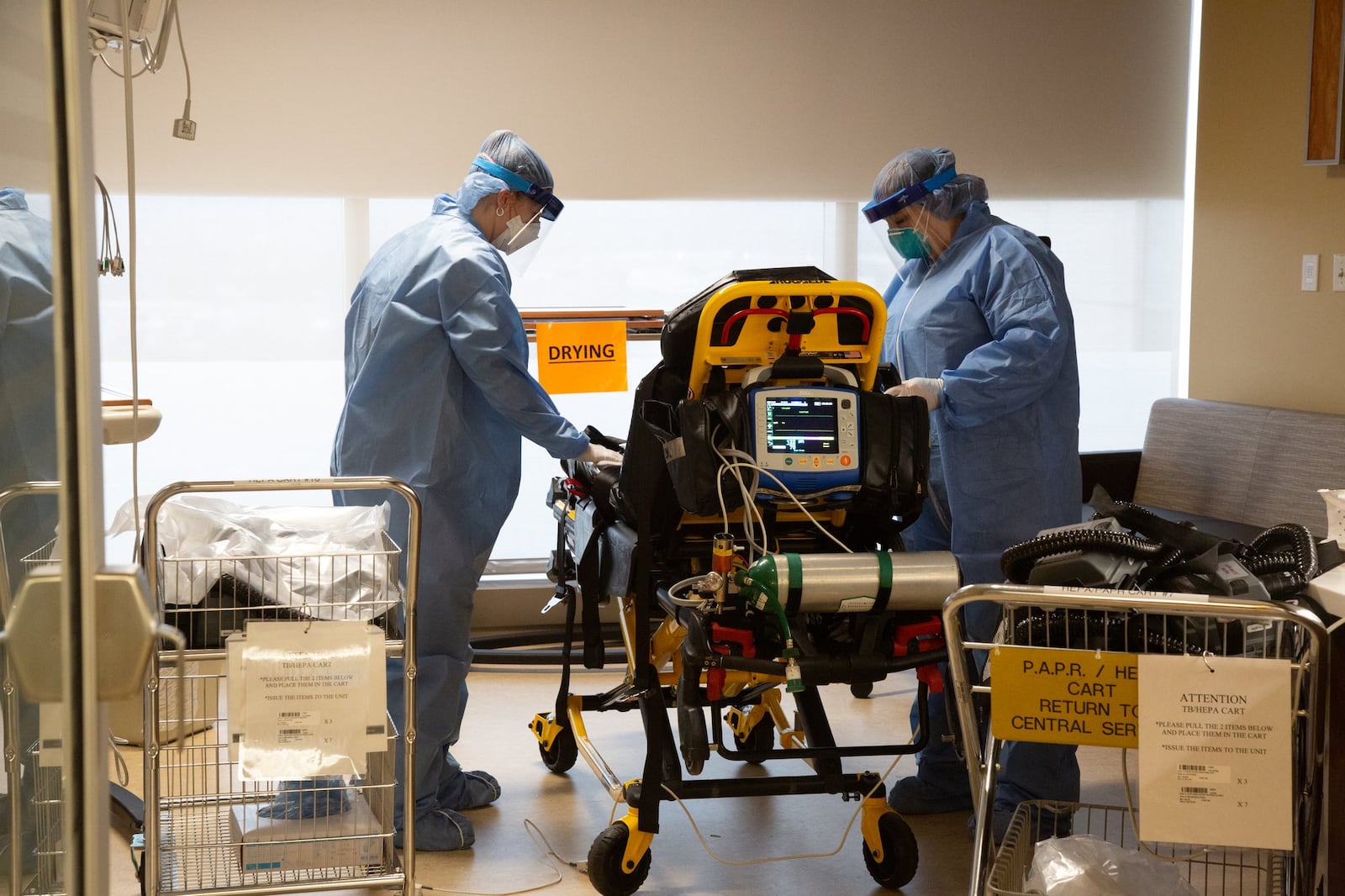 Jessica Oakley and Carol Mousa, flight nurses for Premier Health’s CareFlight Air and Mobile Services, are in the designated decontamination area on the COVID-19 unit, cleaning equipment and a MICU stretcher that were used for a suspected COVID-19 transport.