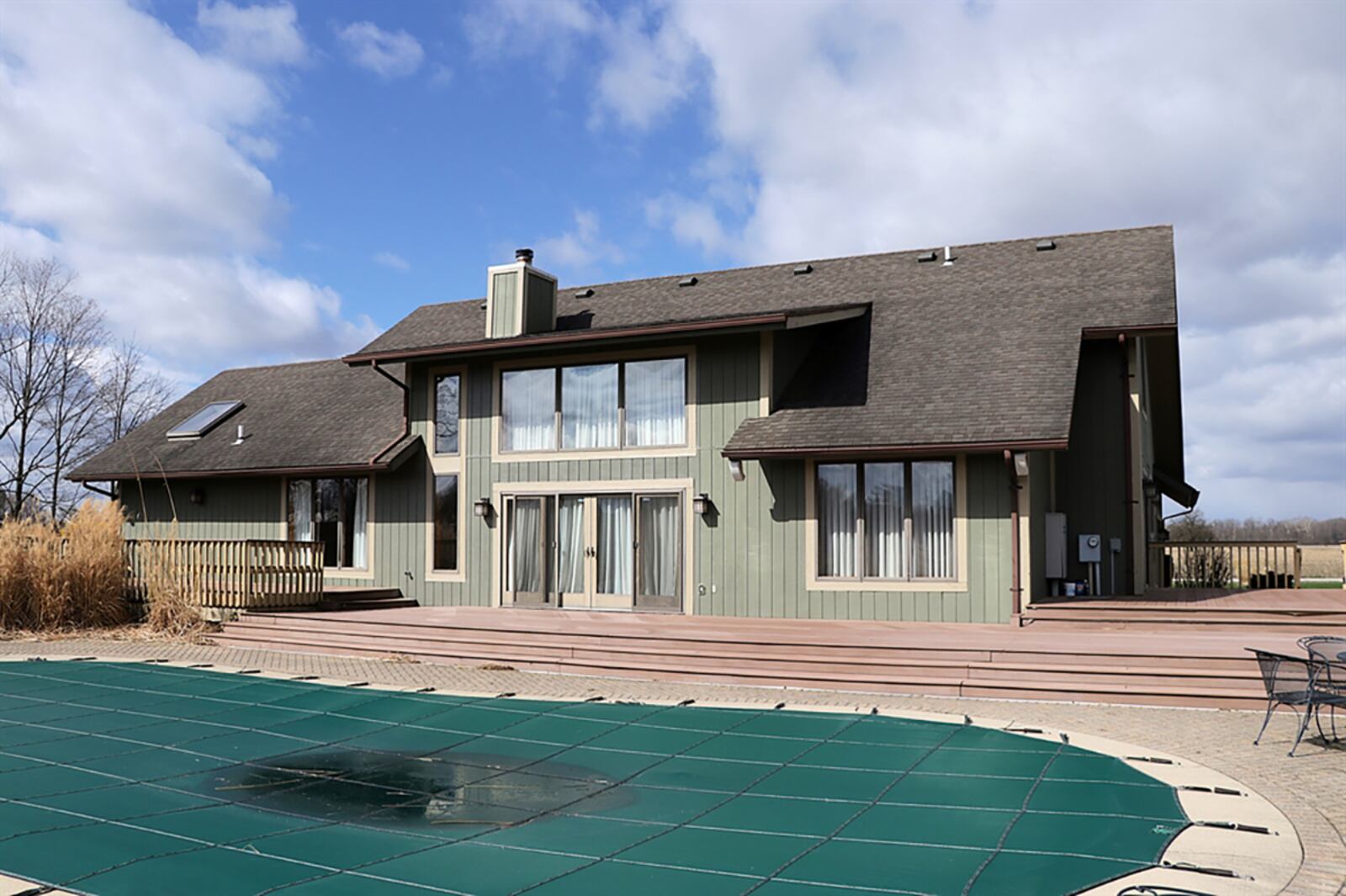 Patio doors from the breakfast room and the great room open to a multi-level composite deck and paver-brick patio that surrounds the in-ground swimming pool. A metal fence accented by a lava rock garden and landscaping adds privacy to the pool area while part of the 5 acres is fenced. CONTRIBUTED PHOTO BY KATHY TYLER