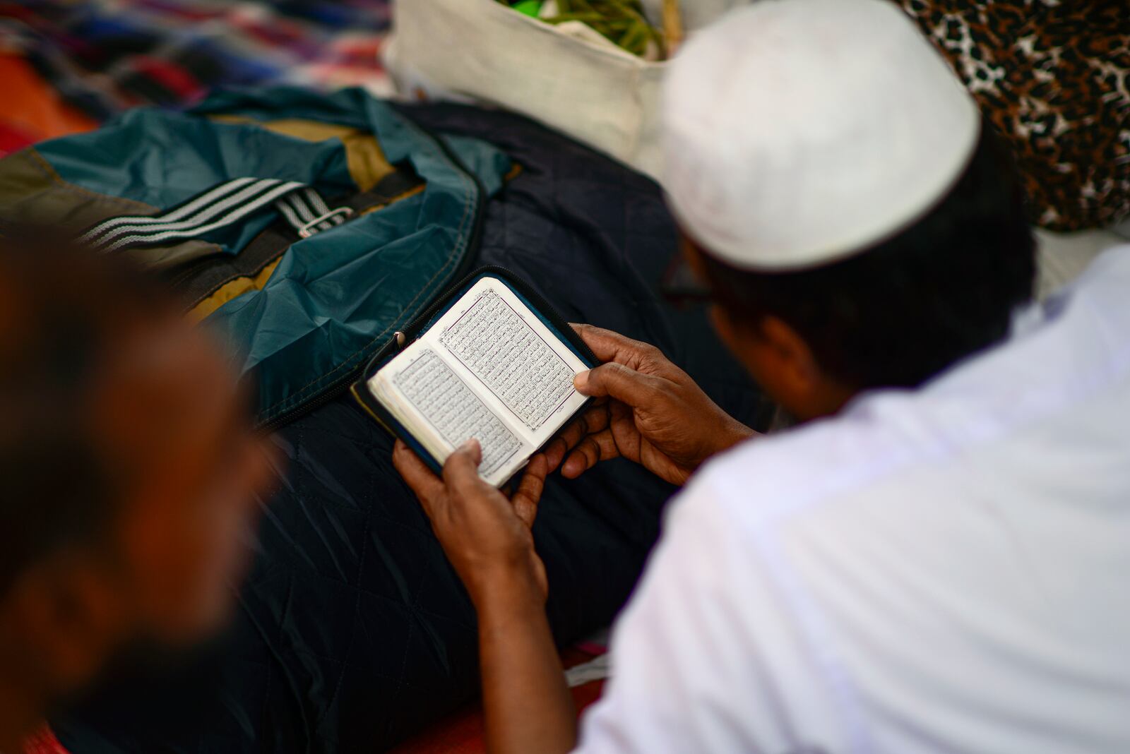 A Muslim devotee reads the Holy Quran in a tent during the first phase of the three-day Biswa Ijtema, or the World Congregation of Muslims, at the banks of the Turag river in Tongi, near Dhaka, Bangladesh, Friday, Jan. 31, 2025. (AP Photo/Mahmud Hossain Opu)