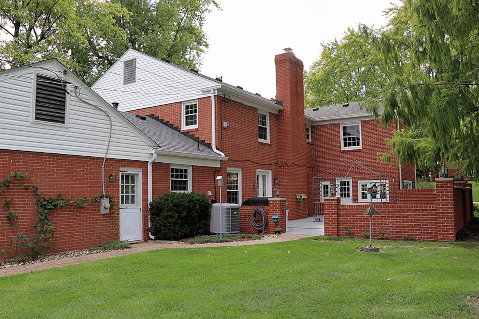 Several windows in the 4-season room provide panoramic views of the back yard. Wood beams accent the ceiling, and a painted-brick plant box is built into one corner. A single door opens to the courtyard patio. Other glass doors open in the family room open to a courtyard patio. CONTRIBUTED PHOTO BY KATHY TYLER