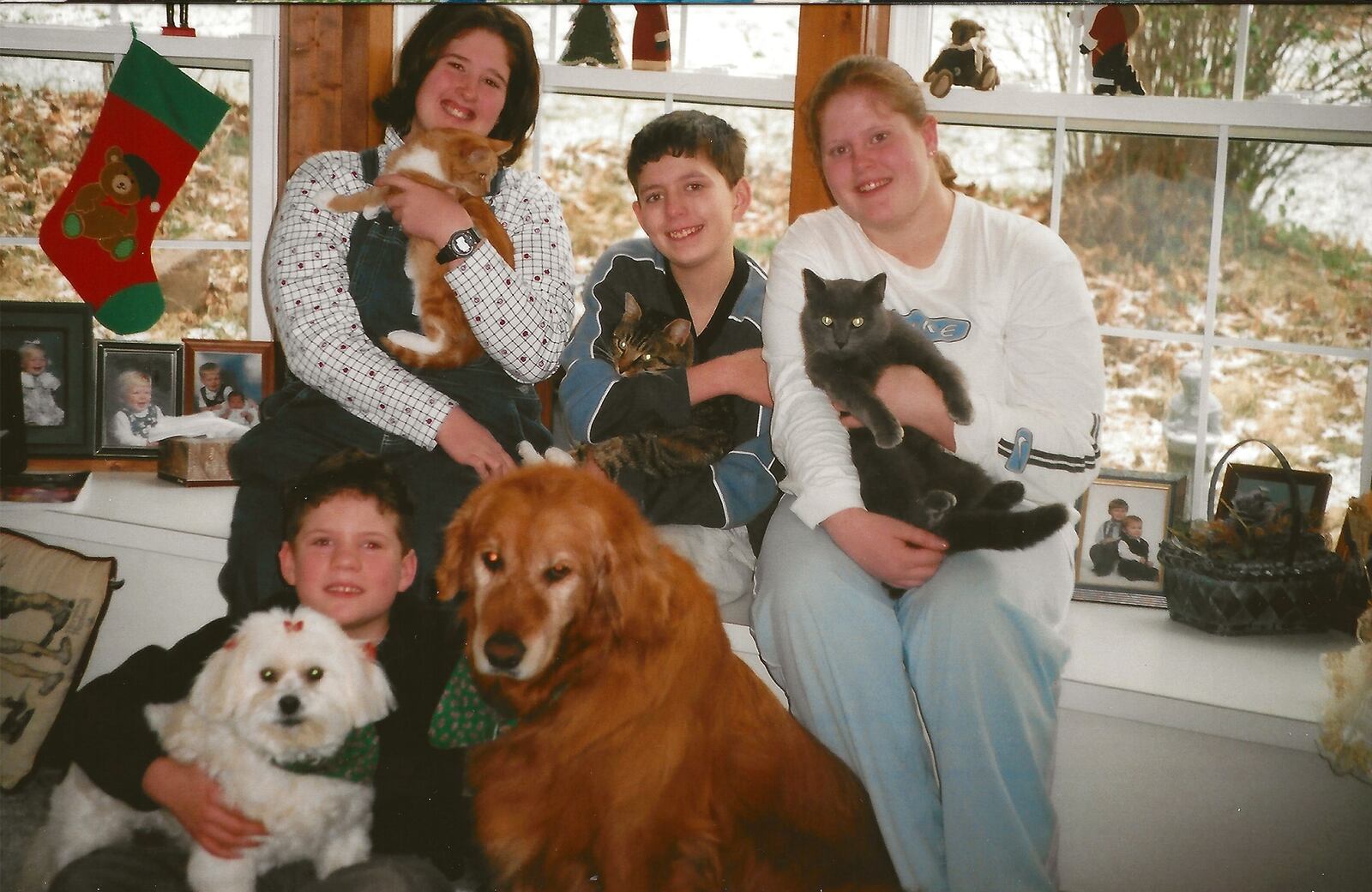 Peggy and Jim Hanna's adopted children Joe on the floor, and (L-R) Lois, Jon and Crystal in 2000. Today, Peggy lives with Crystal and Joe lives next door.