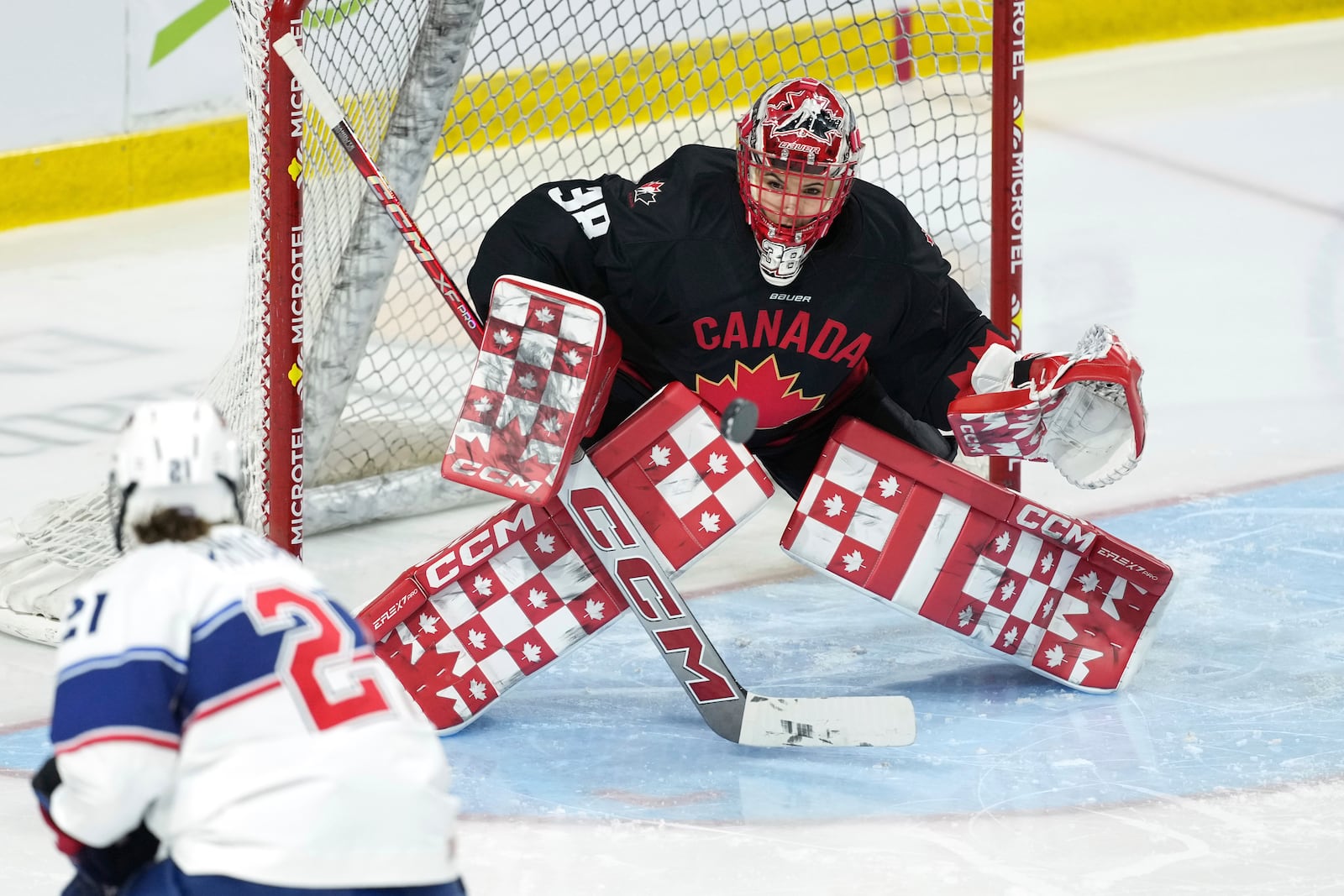 Team Canada goaltender Emerance Maschmeyer, right, makes a save on Team USA's Hilary Knight during the first period of a Rivalry Series hockey game in Summerside, Prince Edward Island, Canada, Saturday, Feb. 8, 2025. (Darren Calabrese/The Canadian Press via AP)