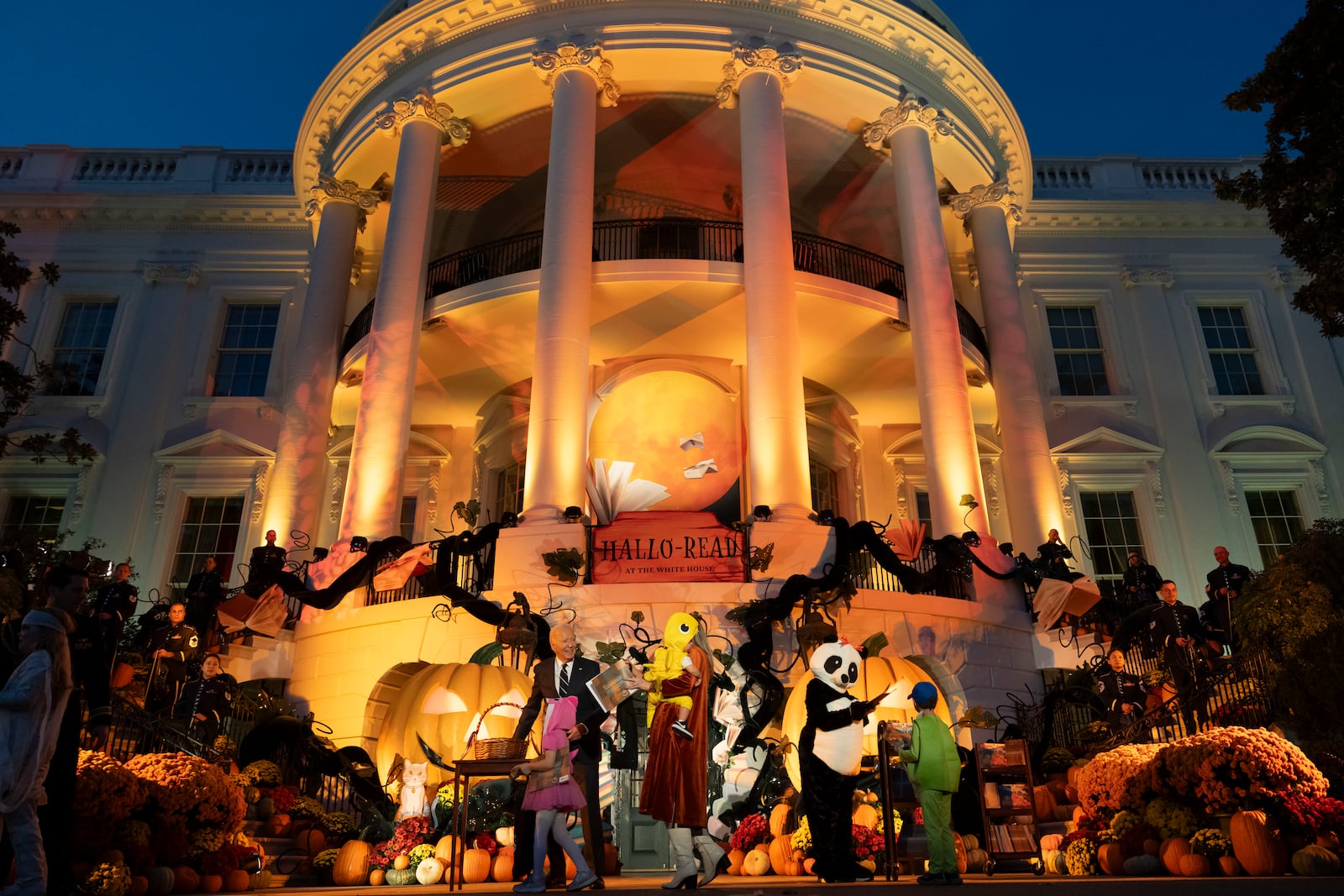 President Joe Biden and first lady Jill Biden, wearing a panda suit, right, host local area students, military-connected children, and neighborhood families for trick-or-treating, ahead of Halloween on Thursday, at the South Lawn of the White House in Washington Wednesday, Oct. 30, 2024. (AP Photo/Ben Curtis)