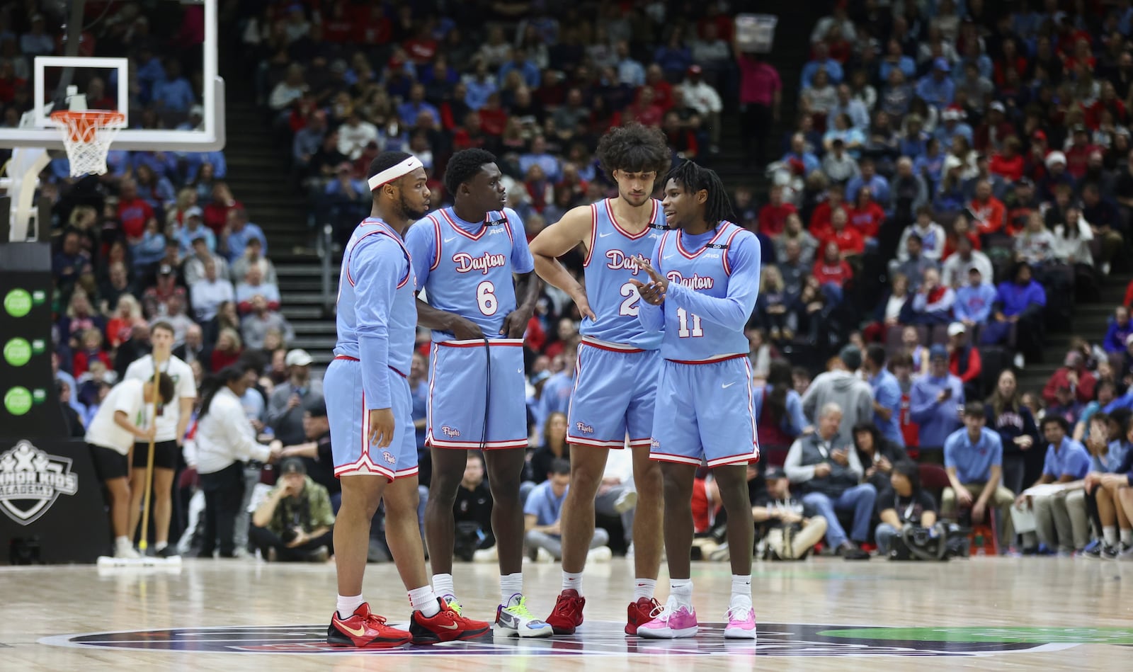 Dayton players huddle during a game against Cincinnati on Friday, Dec. 20, 2024, at the Heritage Bank Center in Cincinnati.