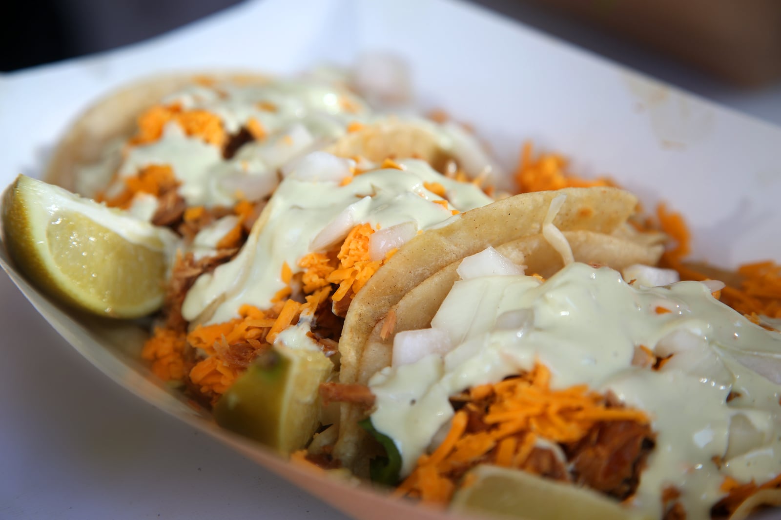 The Momma'z Boyz food trailer makes PHAT Street Tacoz, a combination of corn tortillas, slaw mix, shredded cheddar cheese, onions and a protein that rotates daily. It is finished with avacado cream sauce. It can also be made with veggies. LISA POWELL / STAFF