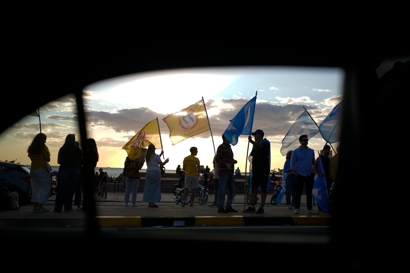 Political party members rally a day ahead of the general election, in Montevideo, Uruguay, Saturday, Oct. 26, 2024. (AP Photo/Natacha Pisarenko)