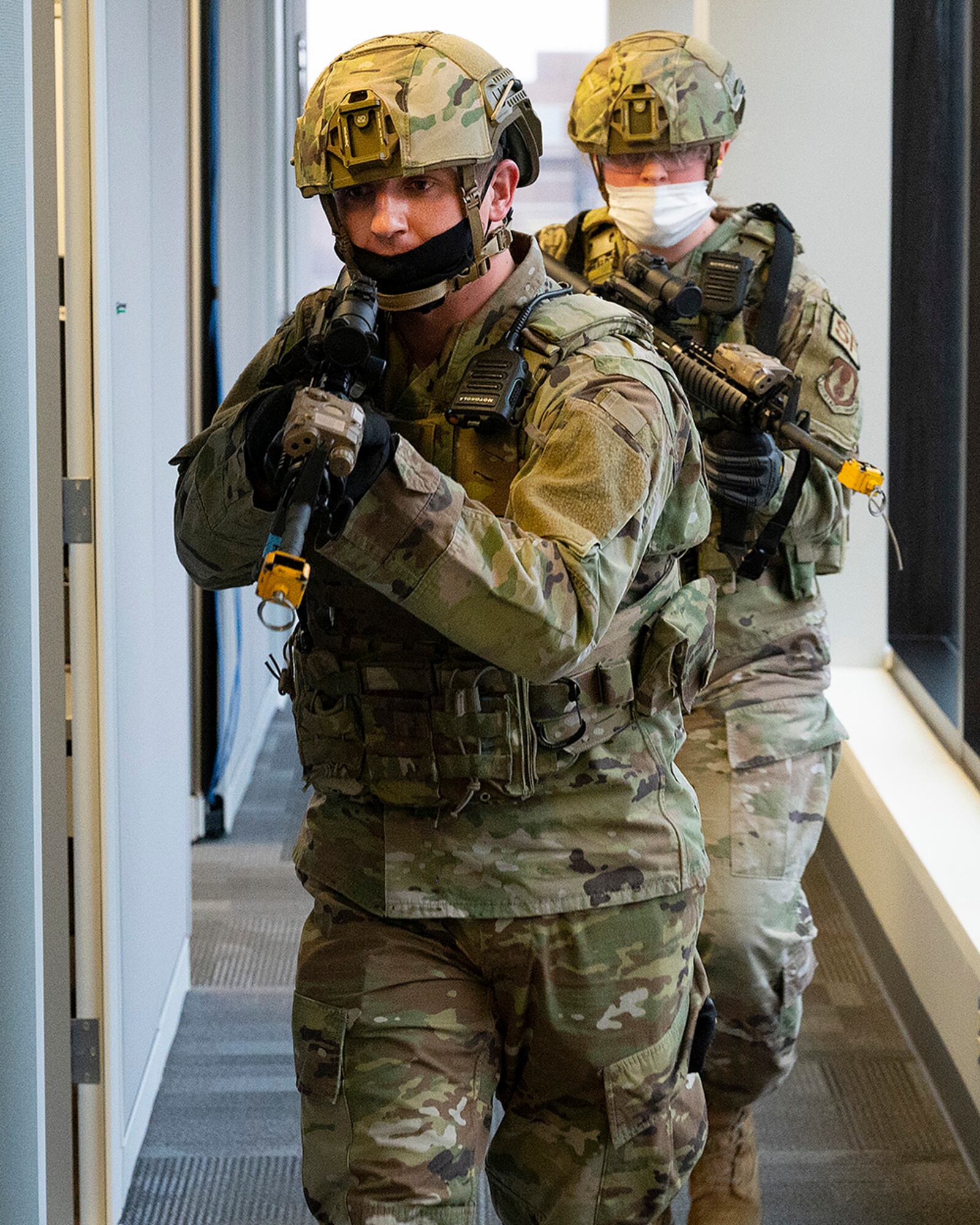 Defenders from the 88th Security Forces Squadron move down a row of cubicles as they clear a building during the active-shooter exercise Feb. 23 at Wright-Patterson Air Force Base. U.S. AIR FORCE PHOTO/R.J. ORIEZ