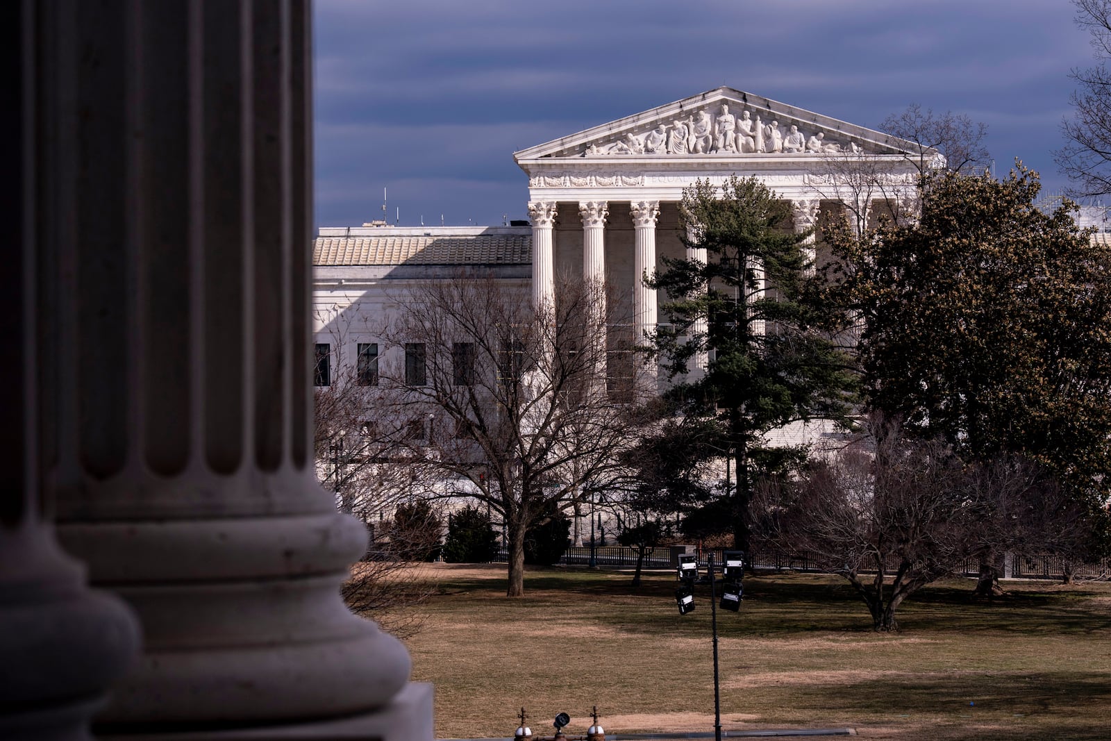 The Supreme Court is seen in the distance, framed through columns of the U.S. Senate at the Capitol in Washington, Thursday, Feb. 20, 2025. (AP Photo/J. Scott Applewhite)