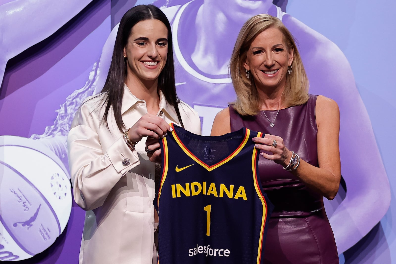 FILE - Iowa's Caitlin Clark, left, poses for a photo with WNBA commissioner Cathy Engelbert, right, after being selected No. 1 overall by the Indiana Fever in the first round of the WNBA basketball draft, Monday, April 15, 2024, in New York. (AP Photo/Adam Hunger, File)